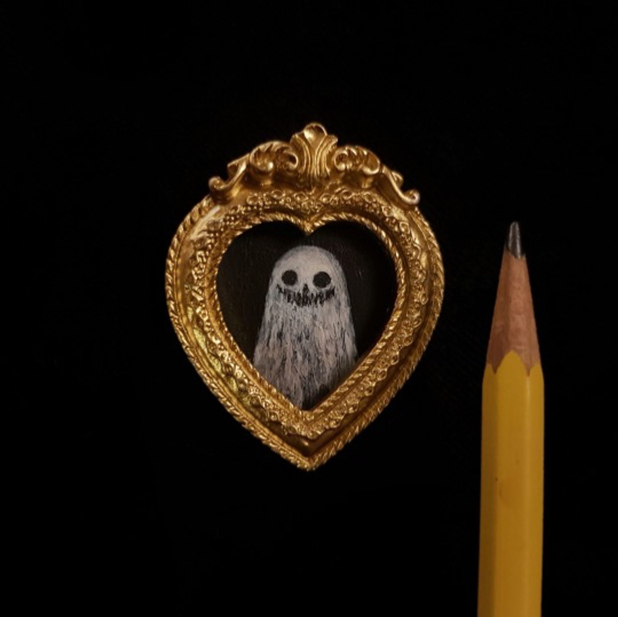 Mini portrait of a ghost next to a pencil tip