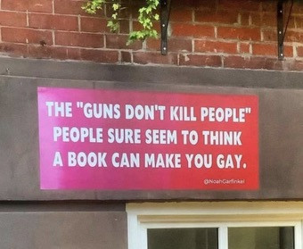 Banner: the "guns don't kill people" people sure seem to think a book can make you gay.