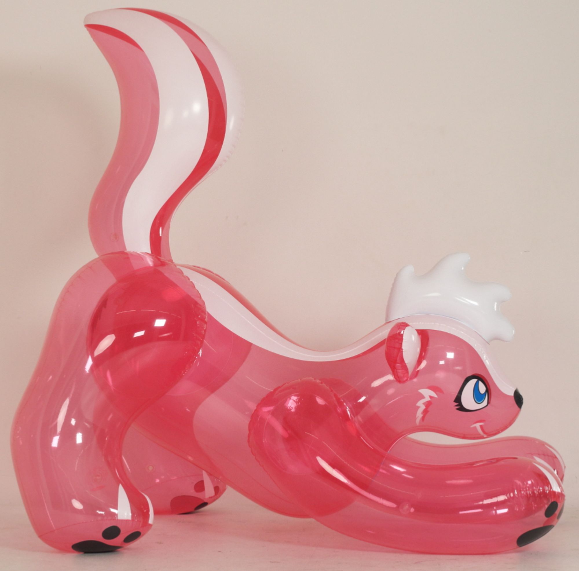 A large, transparent, pink skunk pooltoy in a “pouncing” position.