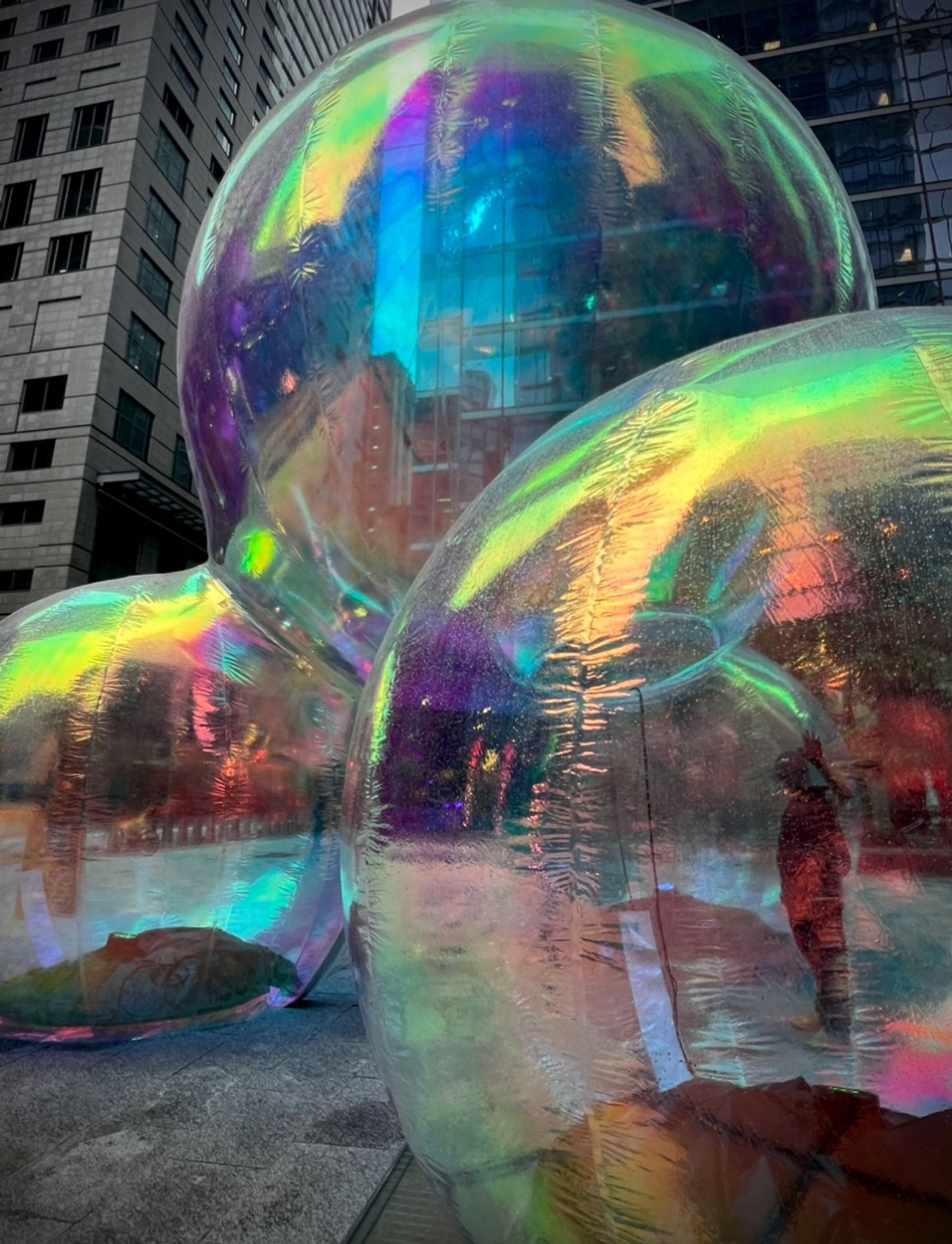 The polyethylene bubbles in a concrete plaza with the shadow od someone