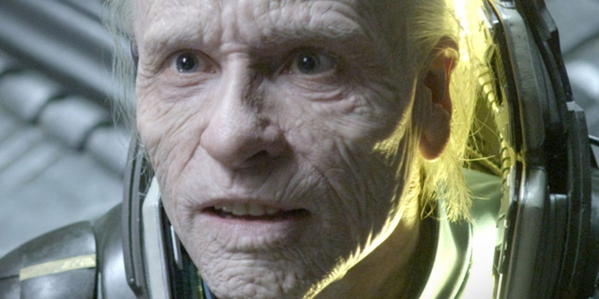 Pictures is a close up of a very old man in a space suit - the character is Peter Wetland from Aliens:Prometheus 

From the wiki: 

Guy Pearce as Peter Weyland:
Weyland is the billionaire founder and CEO of Weyland Corp.

Lindelof described him as having a massive ego and suffering from a god complex