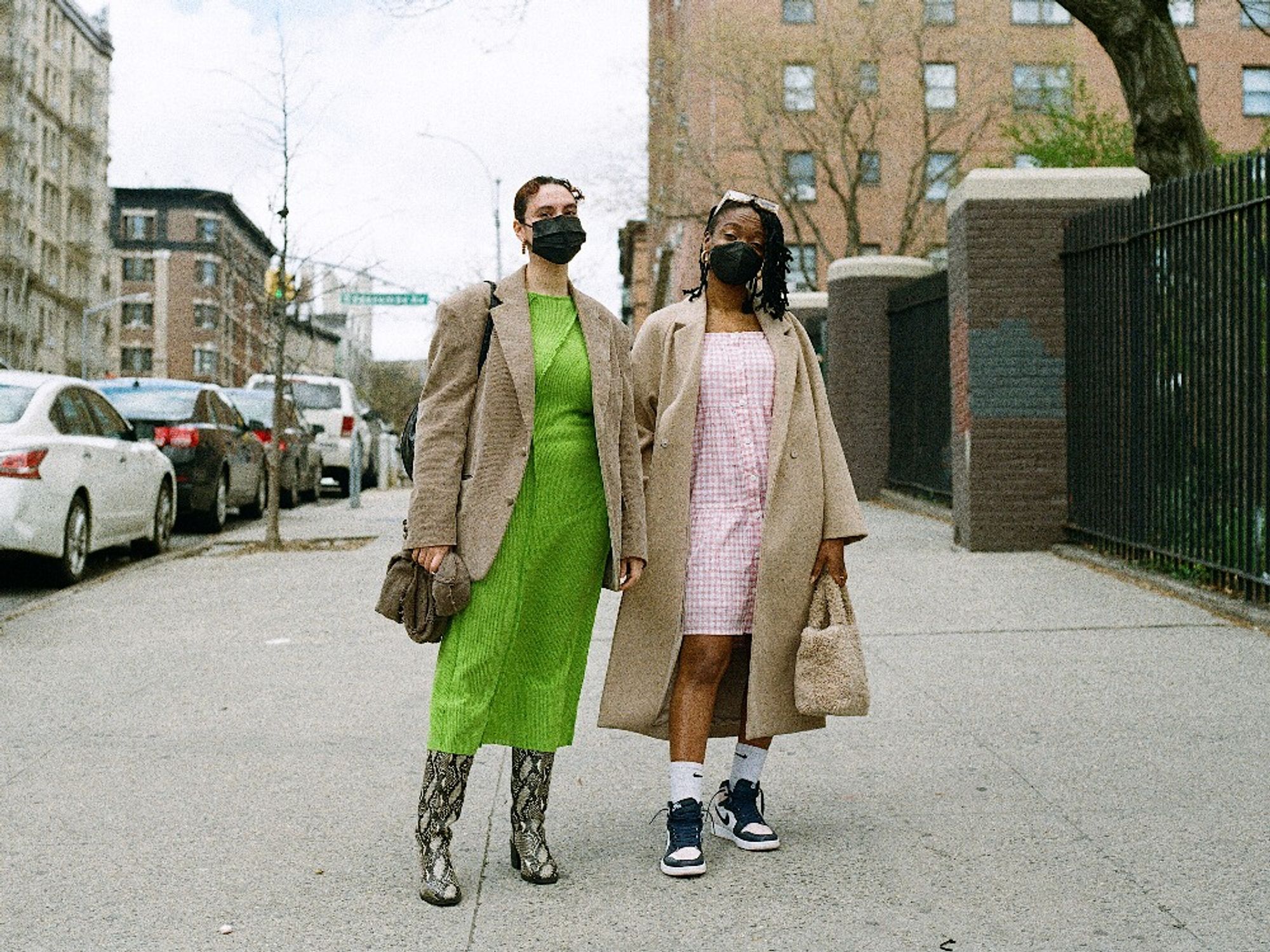 A film photograph made by freelance photographer Victorio Milian. It shows a street portrait of two young Black women on 145th street.