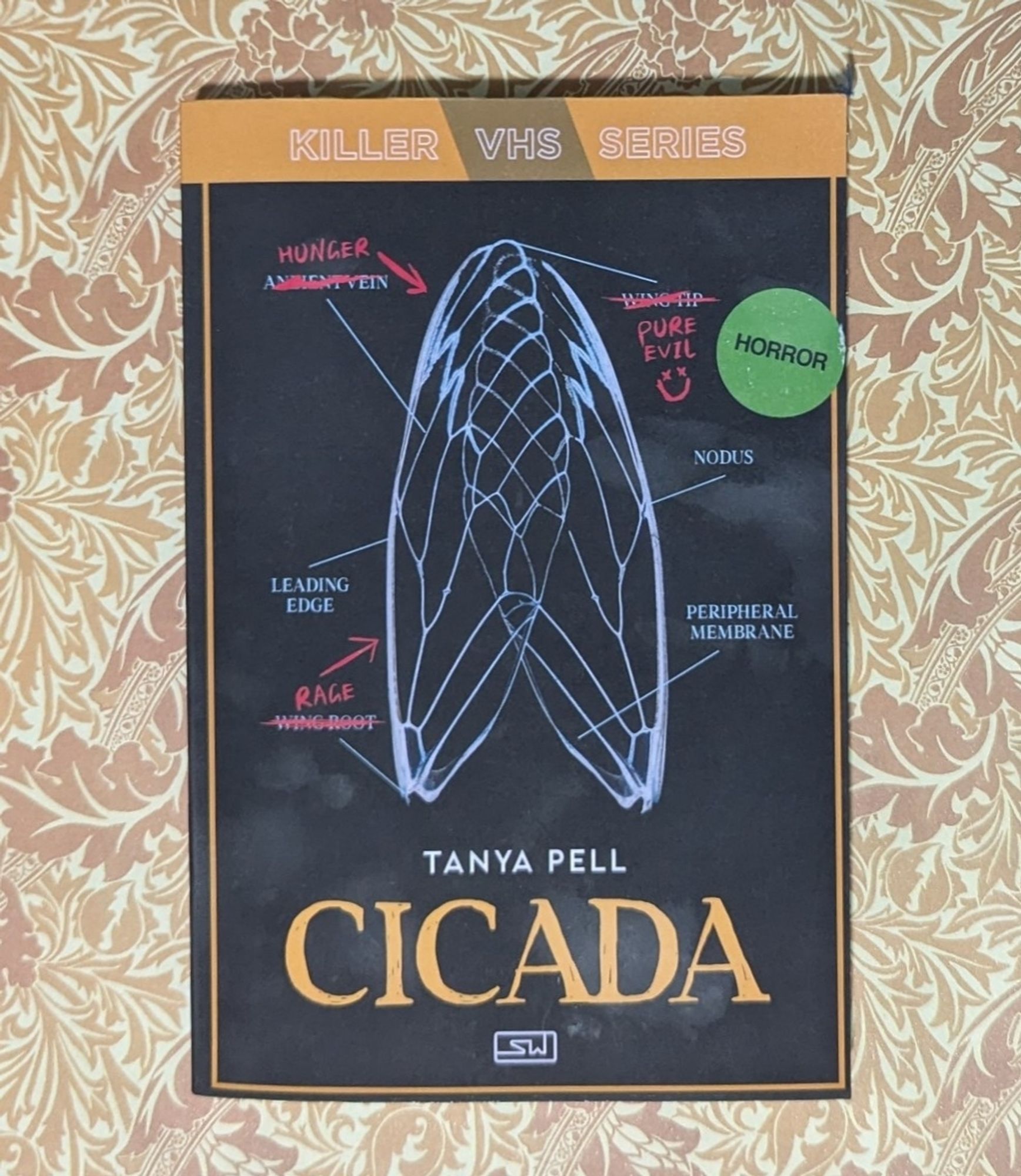 Paperback of Cicada by Tanya Pell. The cover looks like a VHS tape and has an illustration of cicada wings on it.