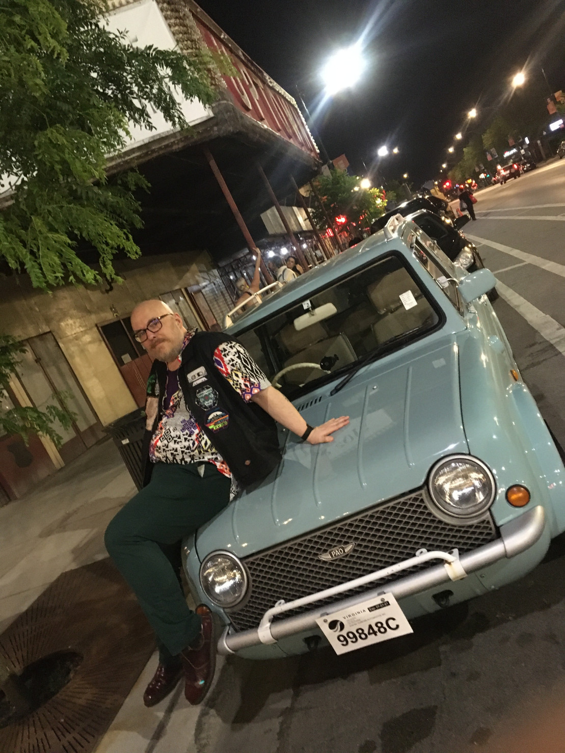 glamorously sprawled on the hood of da nissan pao