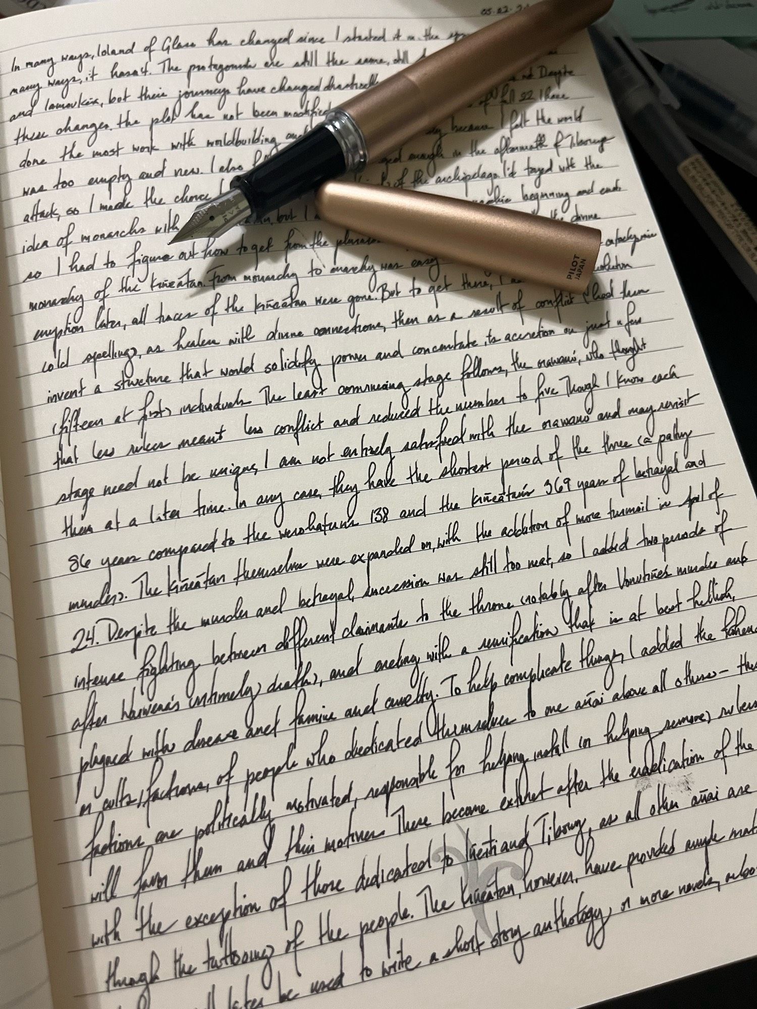 open notebook with a full page of writing and an uncapped fountain pen resting on it