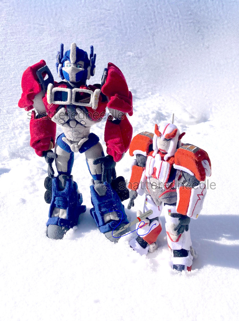 Custom handmade TF Prime Optimus & Ratchet plushes posed in snow