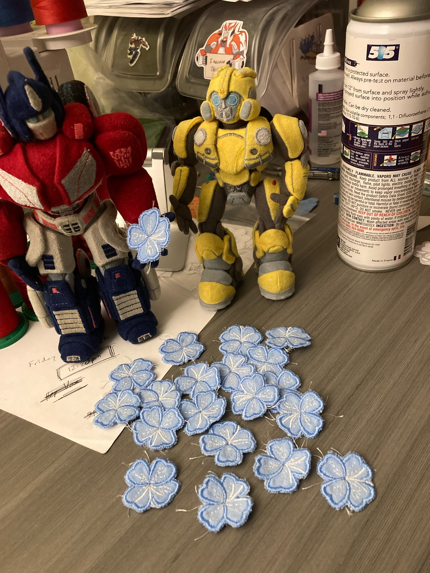 Custom made Optimus & Bee plush looking at custom blue spark flower patches