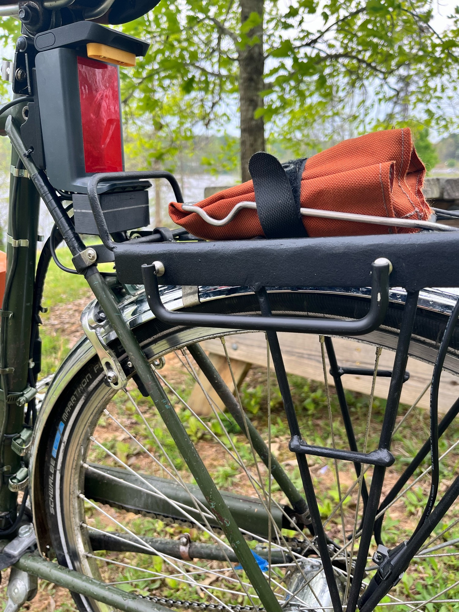 A closer look at the folding u-lock holder, with the bracket folded down against the rear rack.