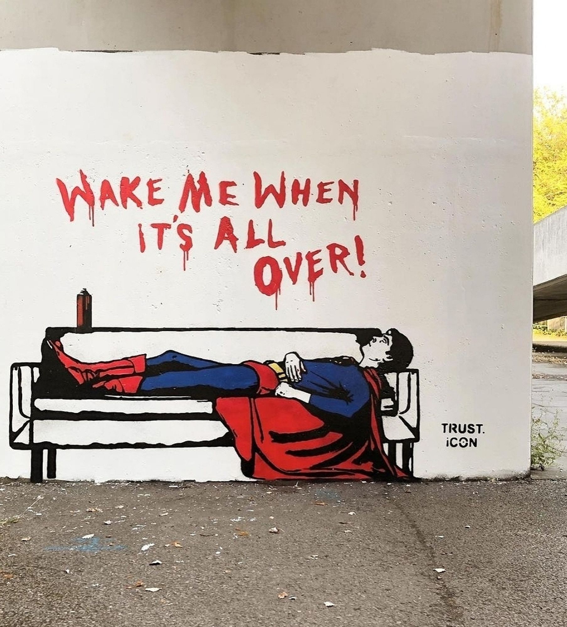 Streetartwall. A funny mural of a very unnerved Superman was sprayed onto a beige-colored exterior wall. The background is painted white. Superman can be seen in his full superhero outfit on a white sofa. There is a spray can of red paint on the sofa and he has sprayed a text in capital letters on the wall above it: "Wake me when it's all over!"
Info: The mural has become a classic and hangs as a poster in many art exhibitions. It simply always fits into any situation.