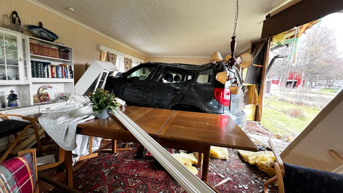 Car that has crashed into someone's livingroom