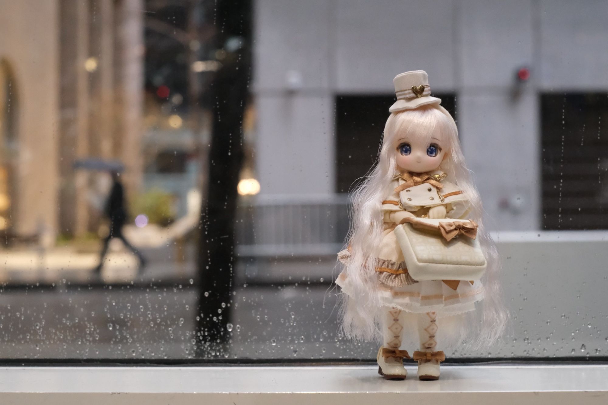 An Azone Sugarcups doll standing in front of a rainy window.