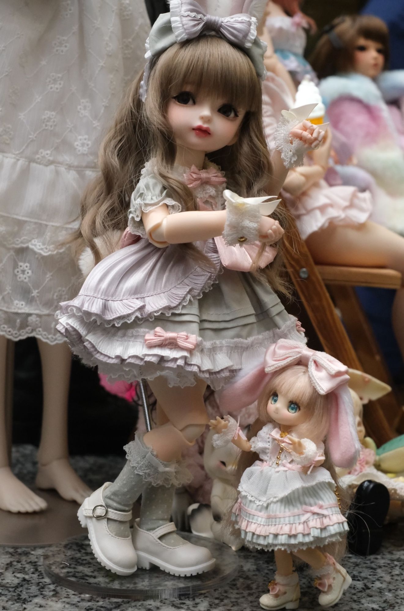 A MYOU Doudou doll making a bunny hop pose with an Azone Sugarcups doll.