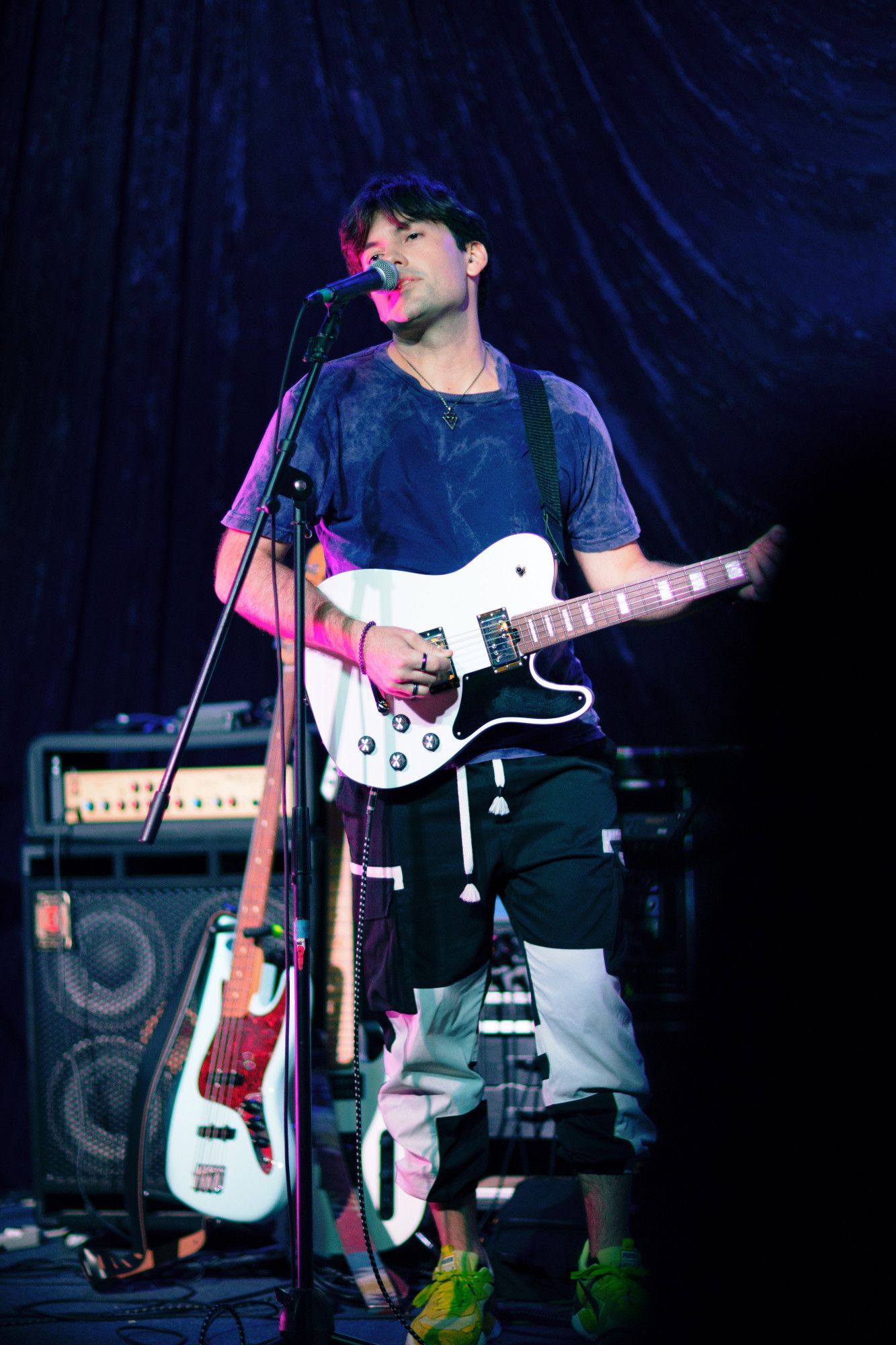 Voia playing guitar while singing.