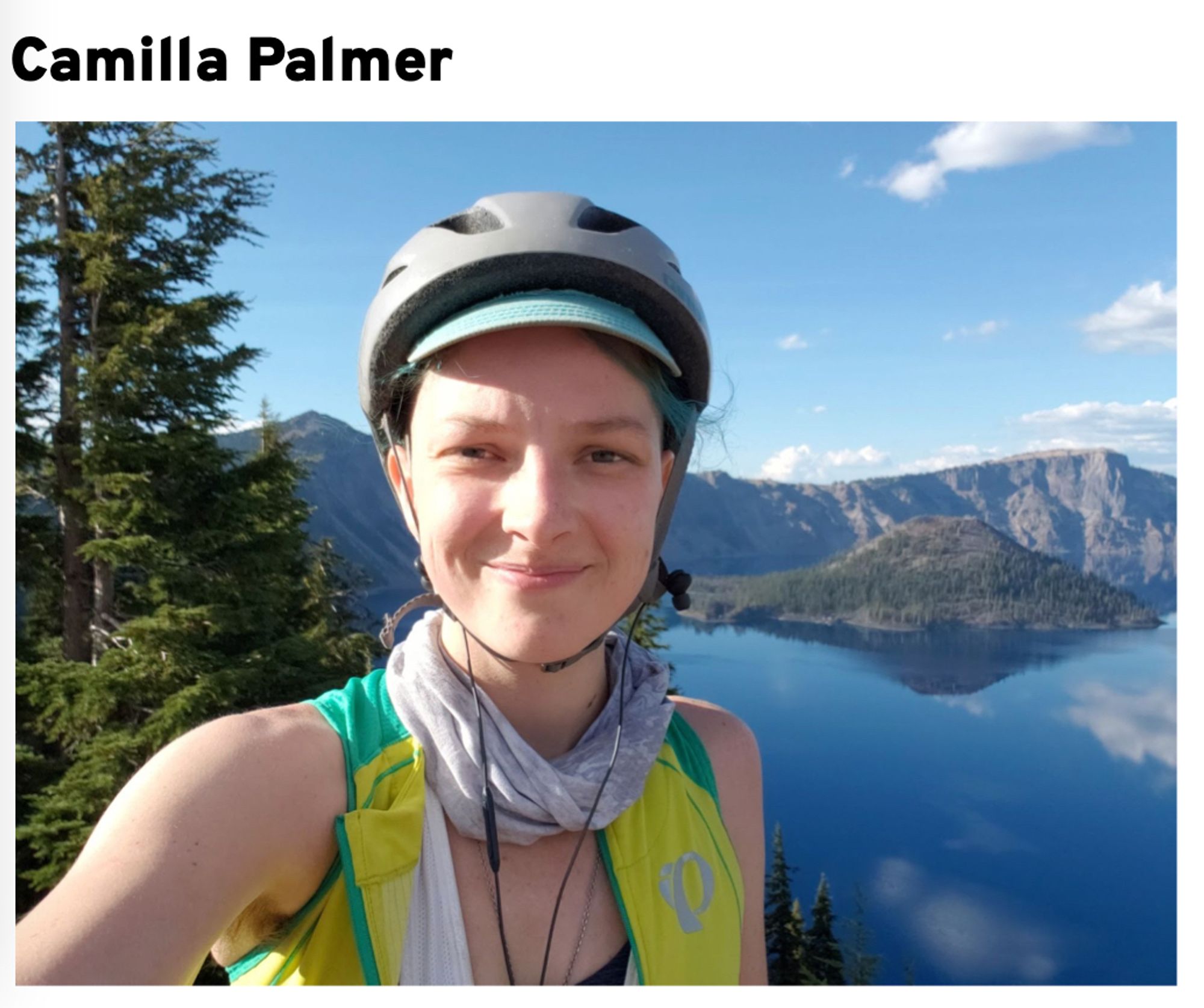 Photo with Camilla Palmer in front of a mountain lake.