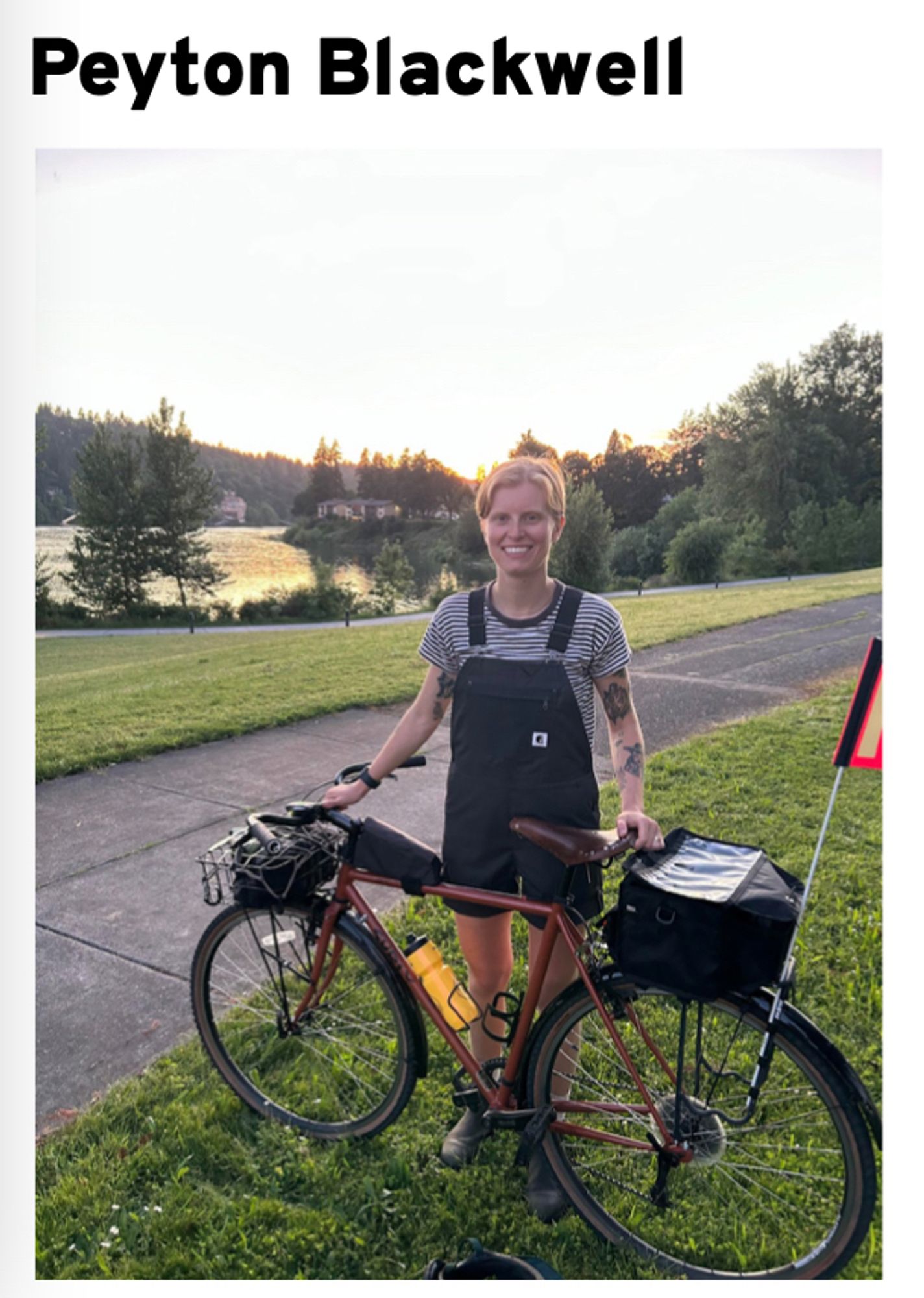 Photo of Peyton Blackwell with a bike in a rural setting.