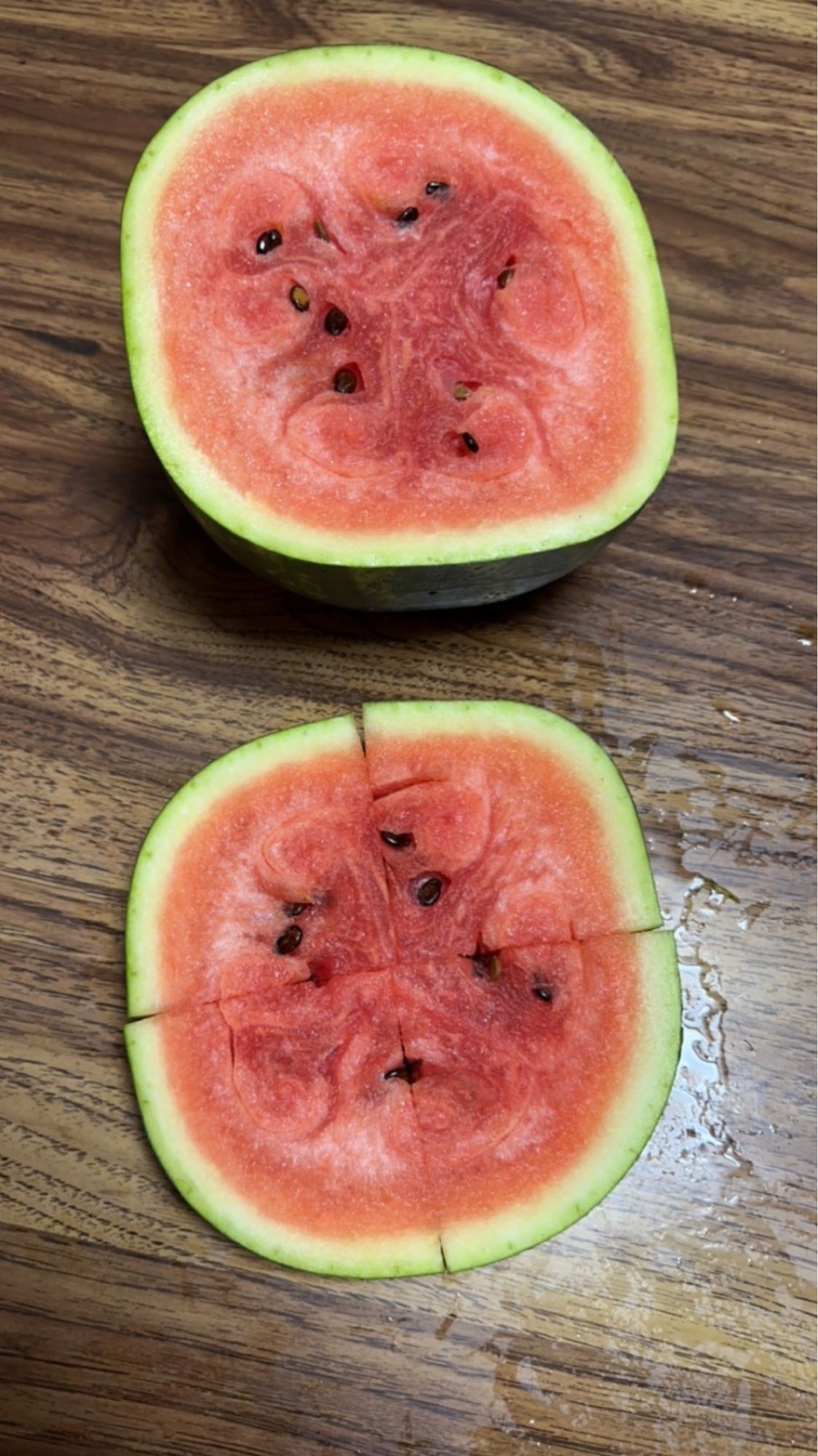 The watermelon cut open with a slice that is squarish in shape.