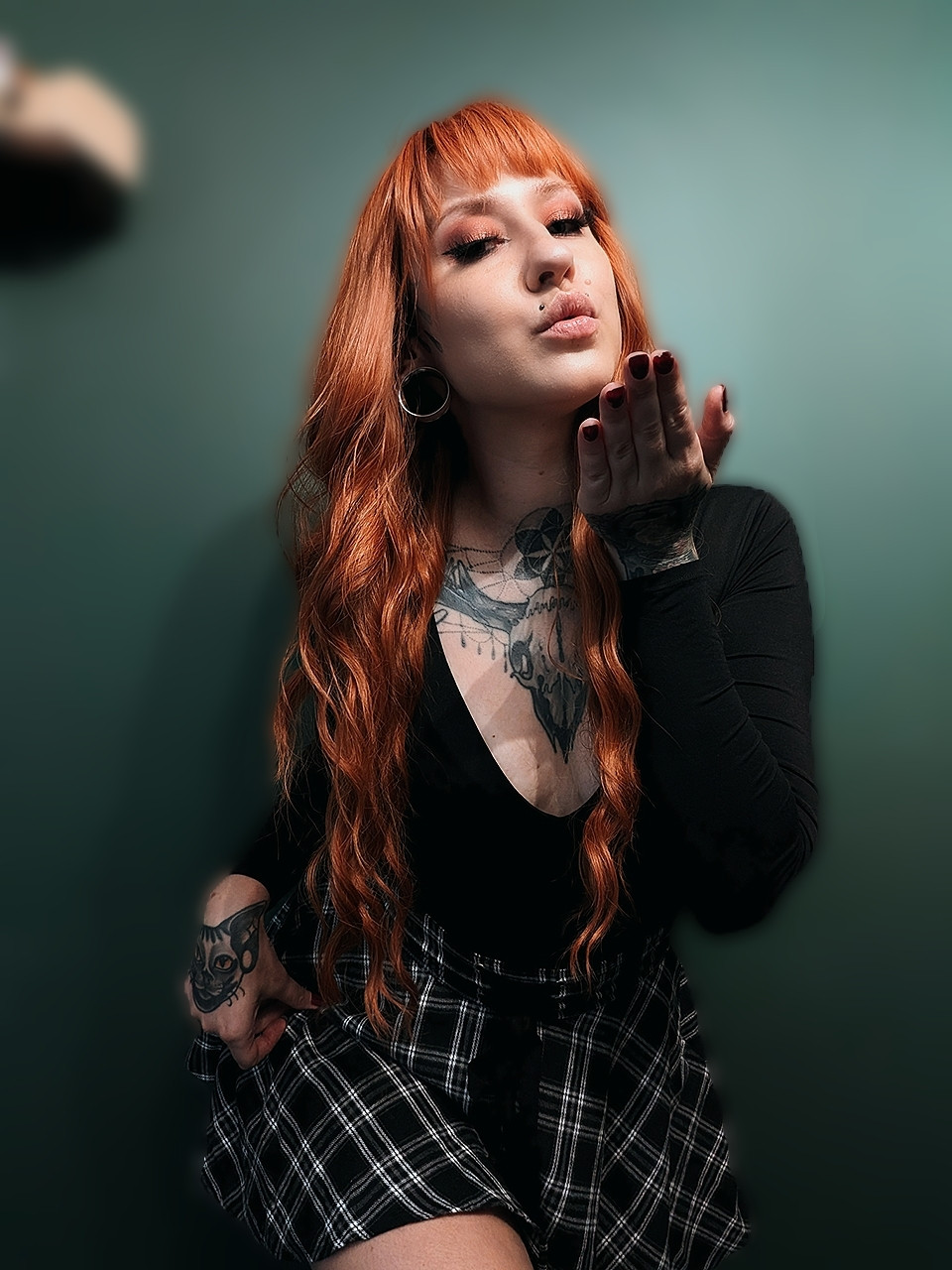 Photo of a girl with ginger hair blowing a kiss