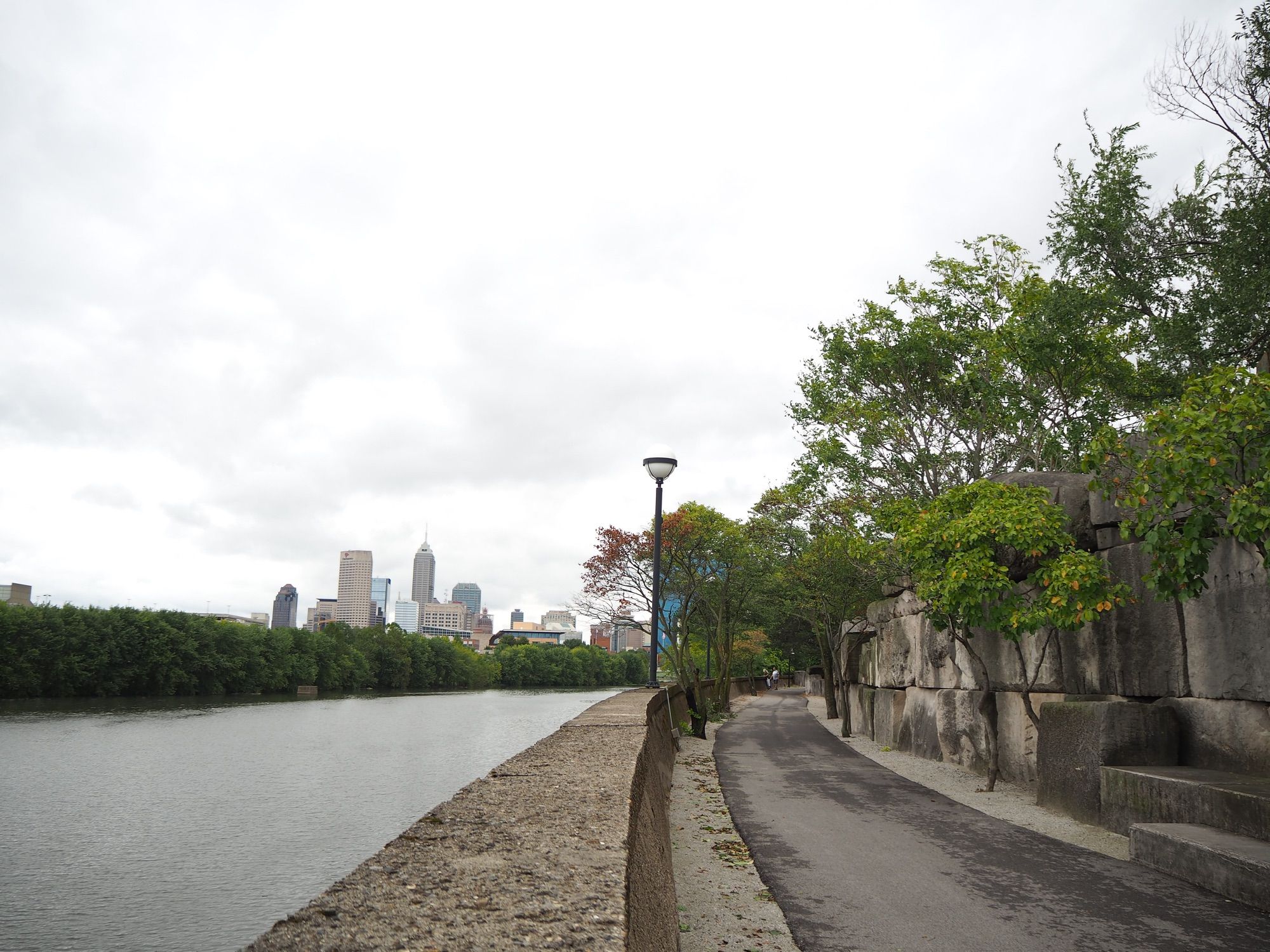 Bike path running parallel to the White River. Downtown Indianapolis can be seen in the background.