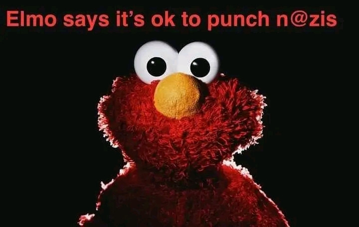 A soon to be unhinged Elmo stares through  the screen, into the reader's soul, and beyond. A single sentence in simple red text reads: "Elmo says it's ok to punch n@zis". 