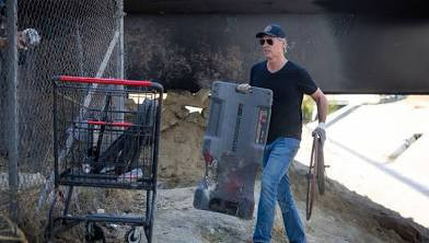 A photo of Gavin Newsom destroying an encampment of unhoused constituents