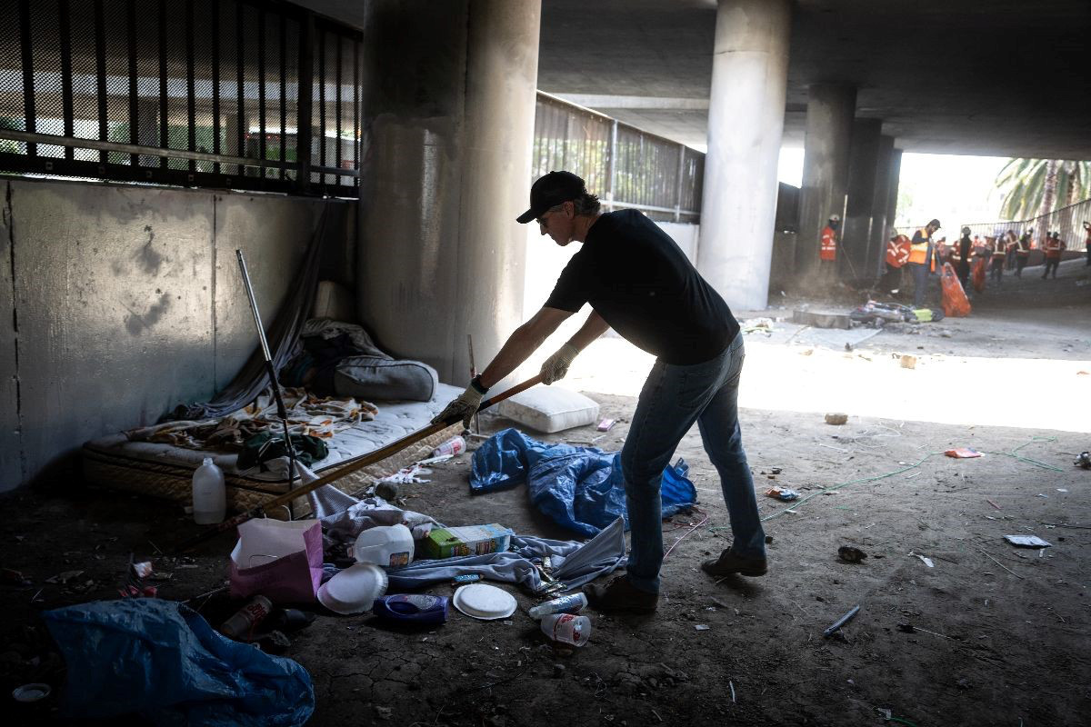 A photo of Gavin Newsom destroying an encampment of unhoused constituents