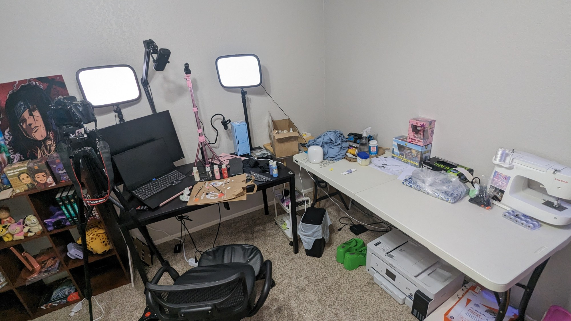 full body picture of my streaming + craft station, besides the descriptors on the other photos here is what else: A kneeling chair, an eco tank 15000 printer, glimpse of my youtooze figurine + collectables shelf, trash can, papers for the printer, and some platform shoes. The steaming desk is to the left, and the craft table is to the right. The area is clean enough, but not tidy.