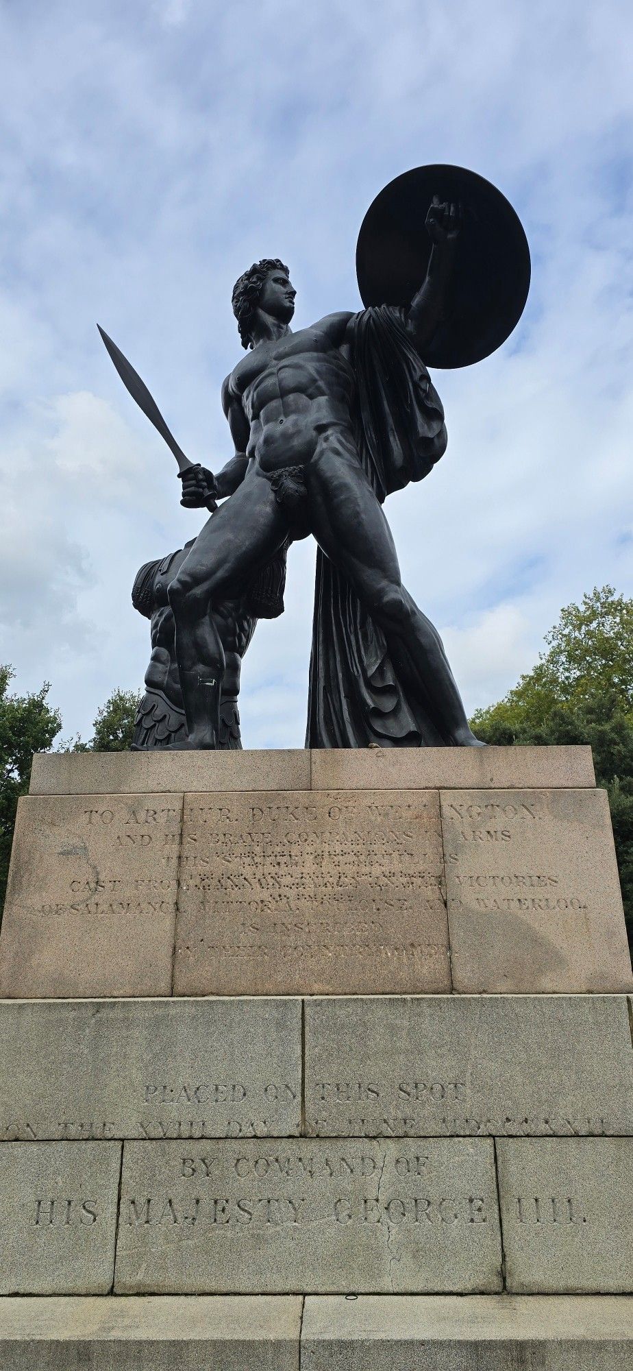 An almost naked statue of Achilles - his armour visibly tossed aside and a curious fig leaf preserving what remains of his modesty - in honour of the Duke of Wellington and his men, ordered by George IV. Found in Hyde Park, London.