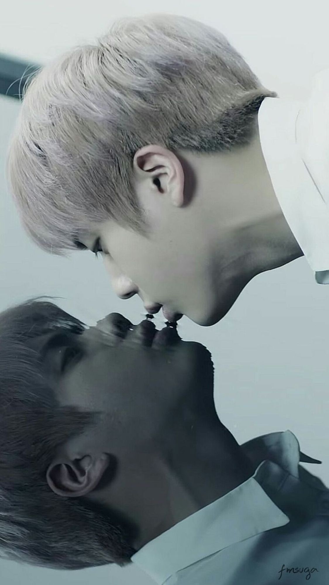 Seokjin kissing his reflection on the water.