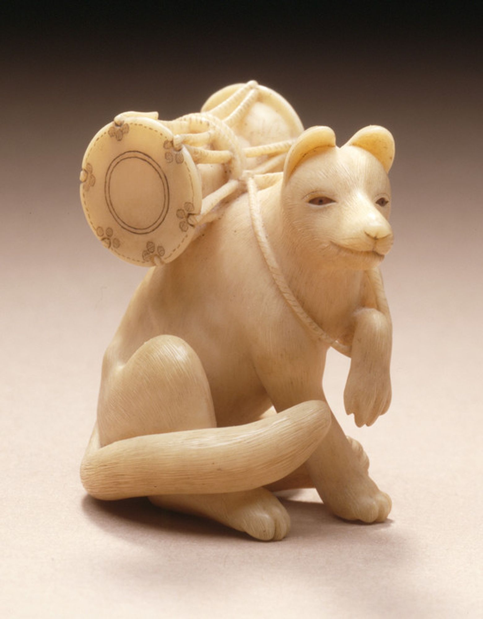 figurine of a fox carrying a drum on their back, ivory with inlays; Los Angeles County Museum of Art