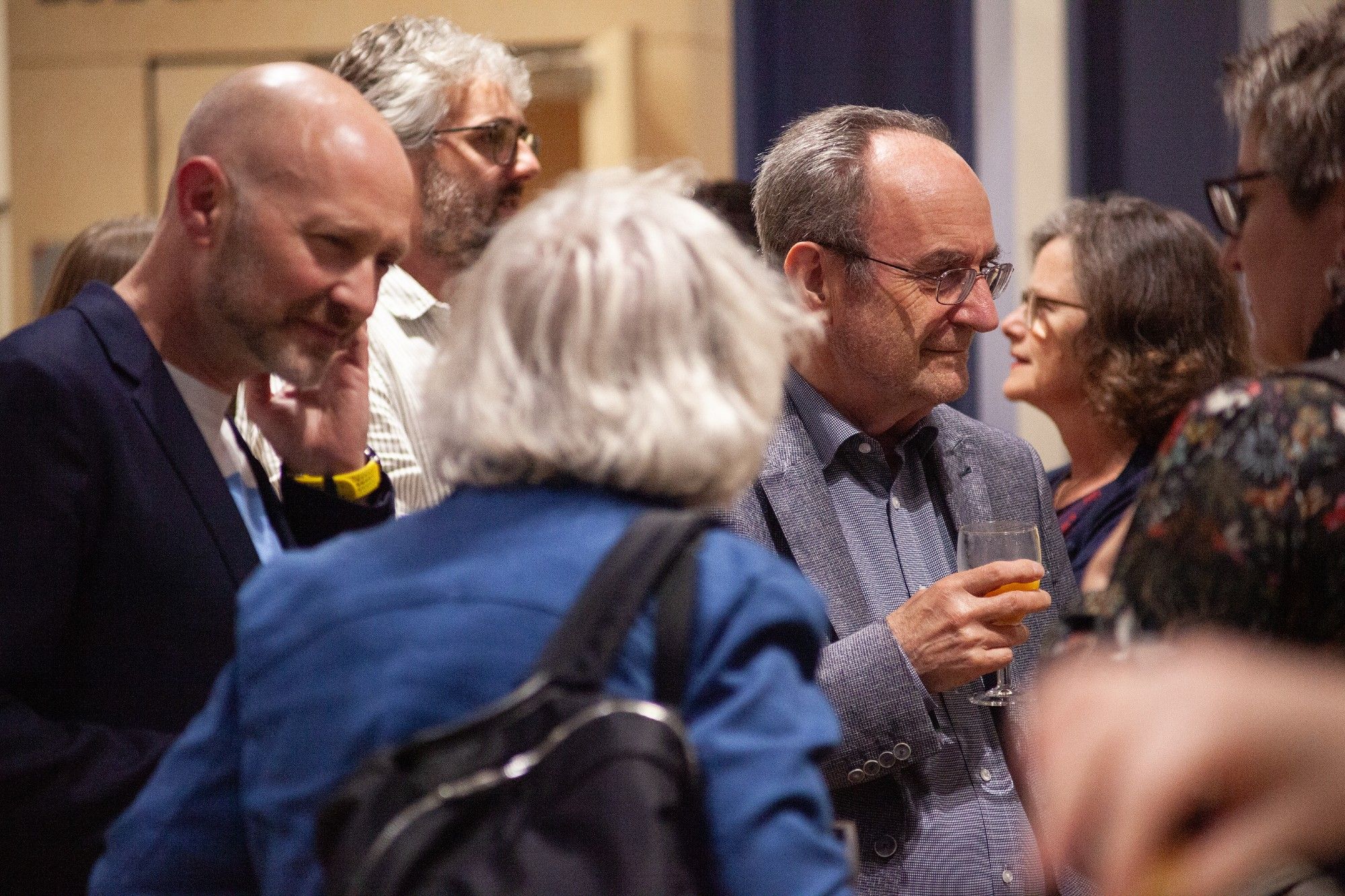 Around 10 delegates, mingling after the talks