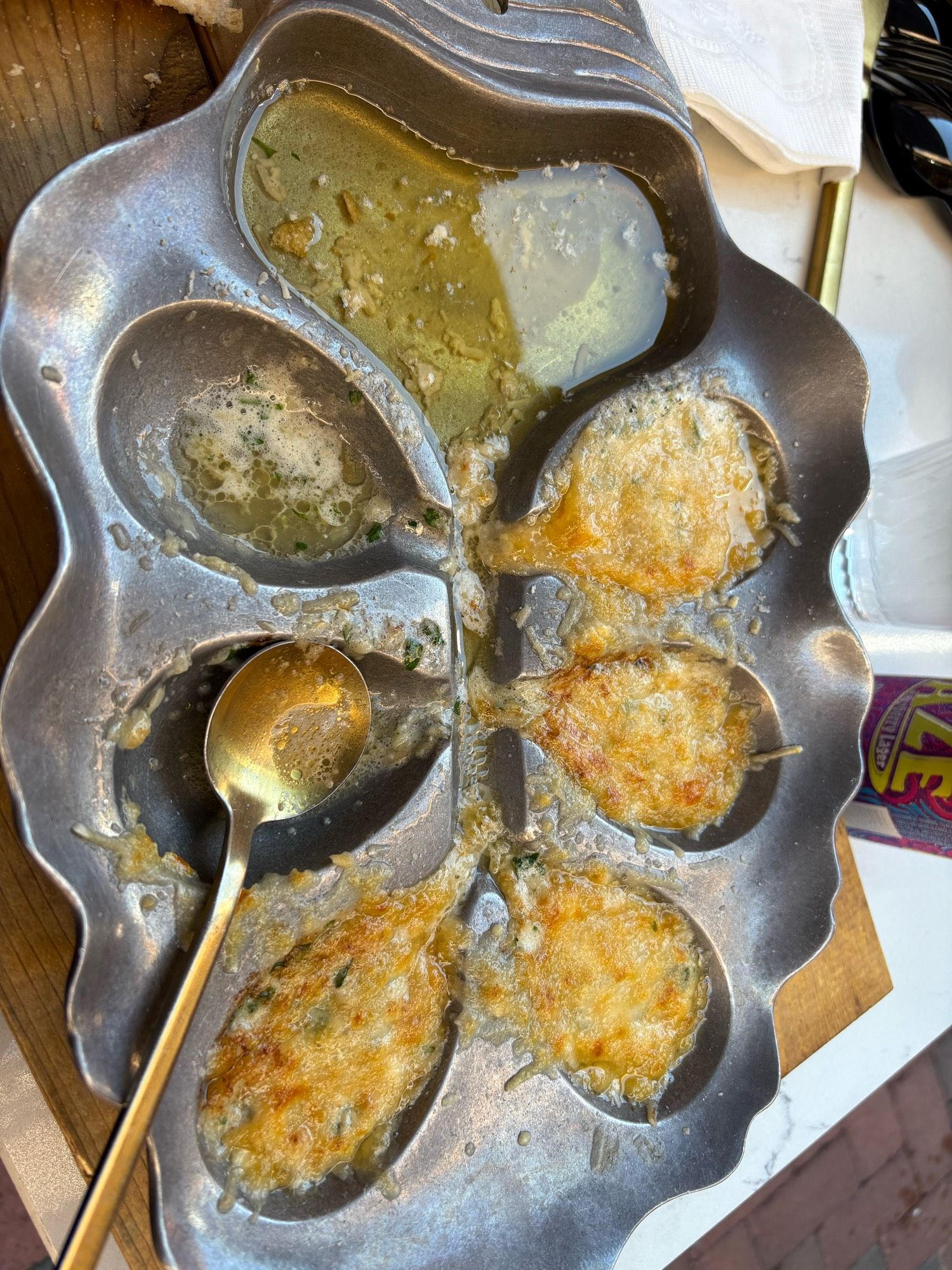 A metal tray with oblong indentations. The indentations are filled with butter, cheese, and oysters that have all been broiled. The tray has a trough running down the middle to collect all the butter so you can sop it up with bread. Absolute gut bomb but it tasted amazing.