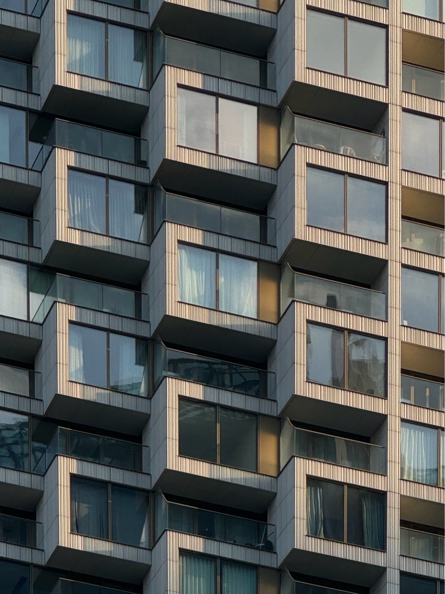 Residential tower block in Canary Whatf - close up of a few square windows and repeated patterns.