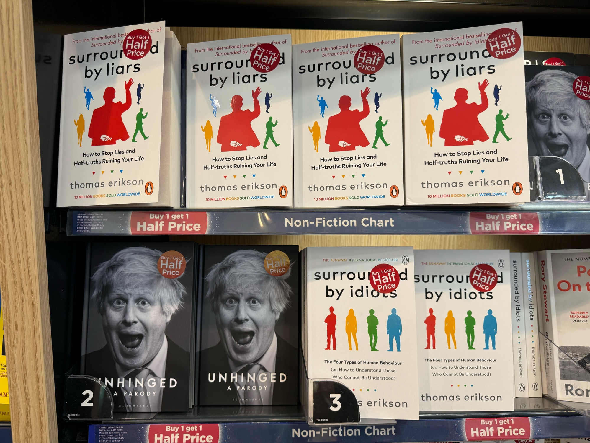 Boris Johnson’s book surrounded nicely by other books entitled Surrounded by Idiots and Surrounded by Liars. 