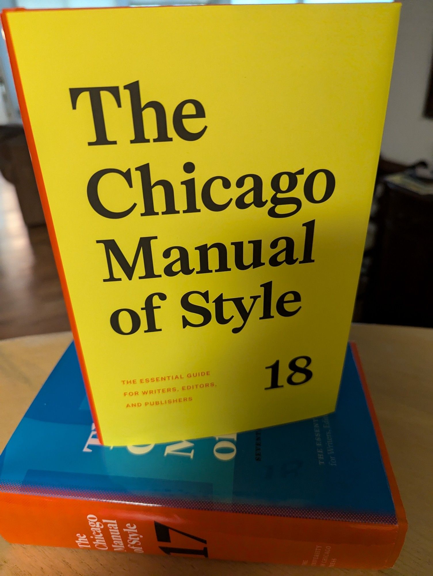 The eighteenth edition of the Chicago Manual of Style sits atop the seventeenth edition