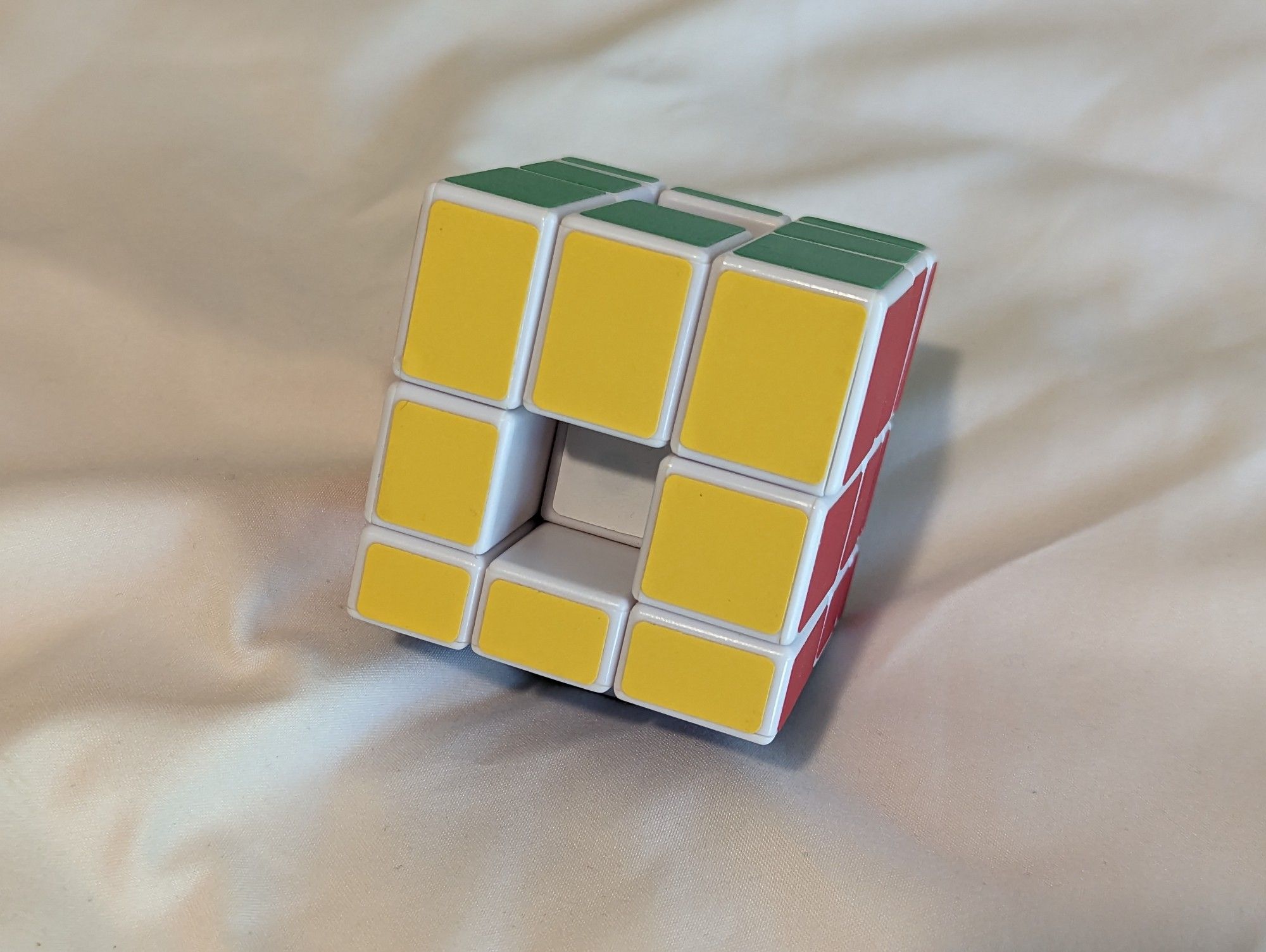 A picture of a trainer Mirror Cube with four centers swapped to make the deepest possible hole