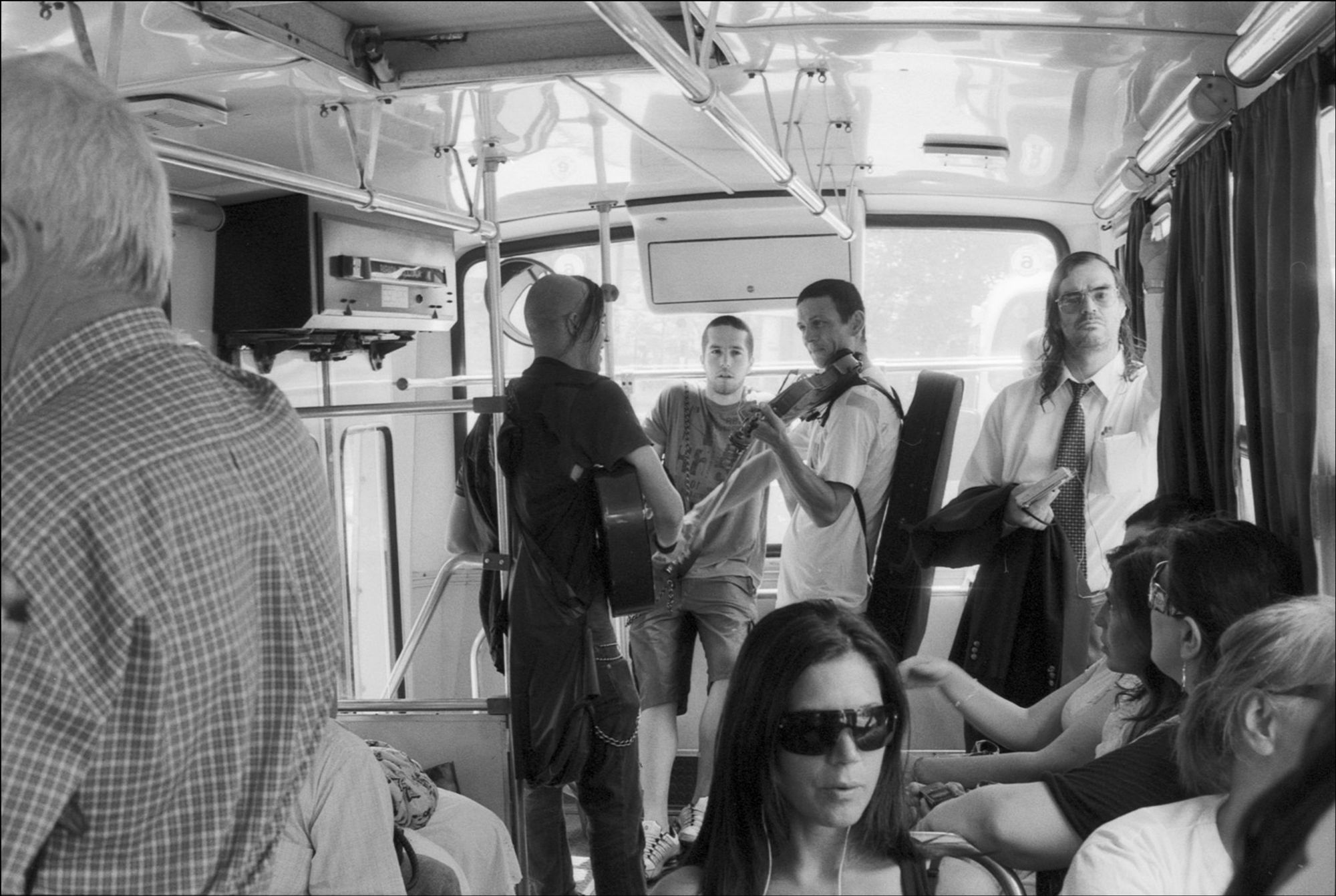 A violinist and a guitarist busking in a city bus, Montevideo, Uruguay, 2010.