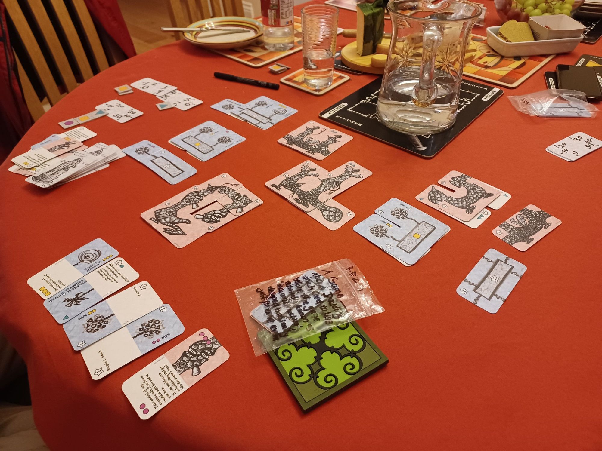 A game in progress. The cards 'in hand' are half blue or red (to connect with other stuff) and half a spell. 

One of the creatures is dangling over in a funny way because of the corners.