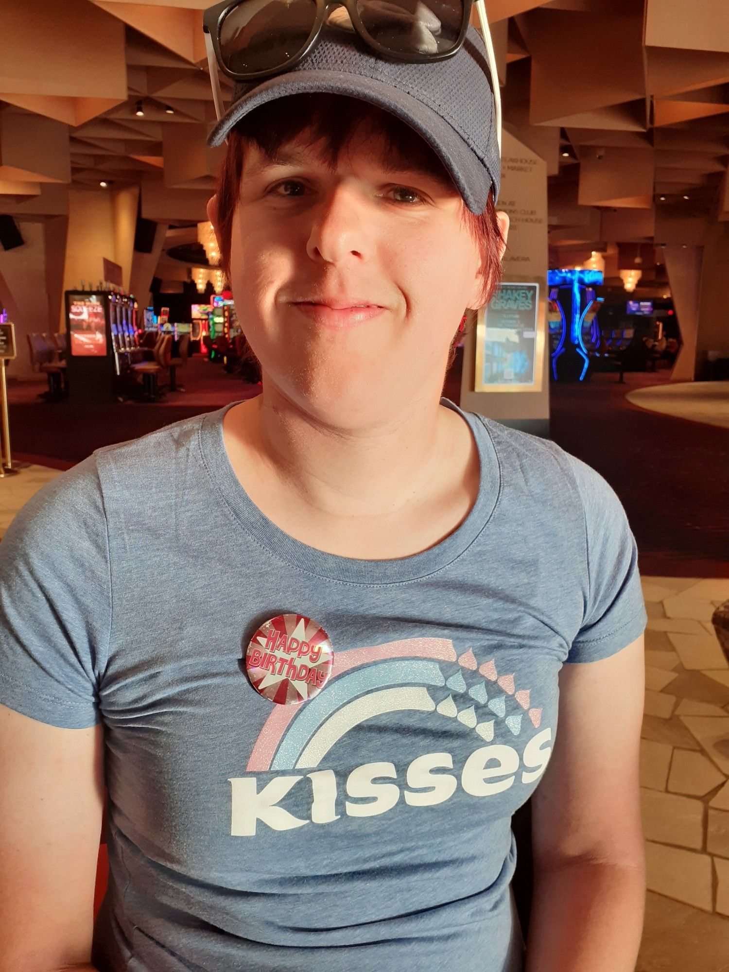 Autumn wearing a navy Under Armour cap and a blue Hershey Kisses Trans flag shirt