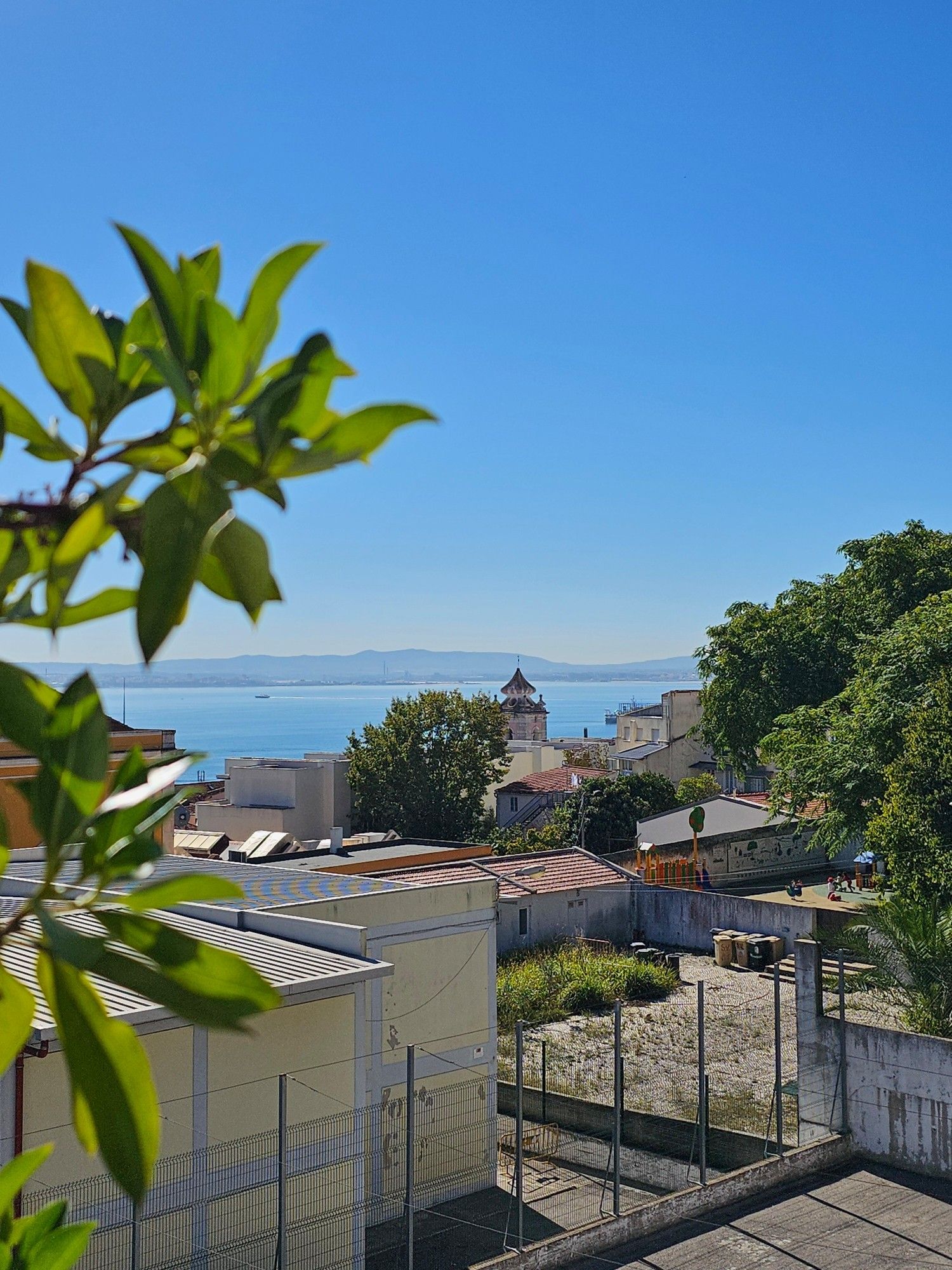 A small church, trees and the Tejo in the background