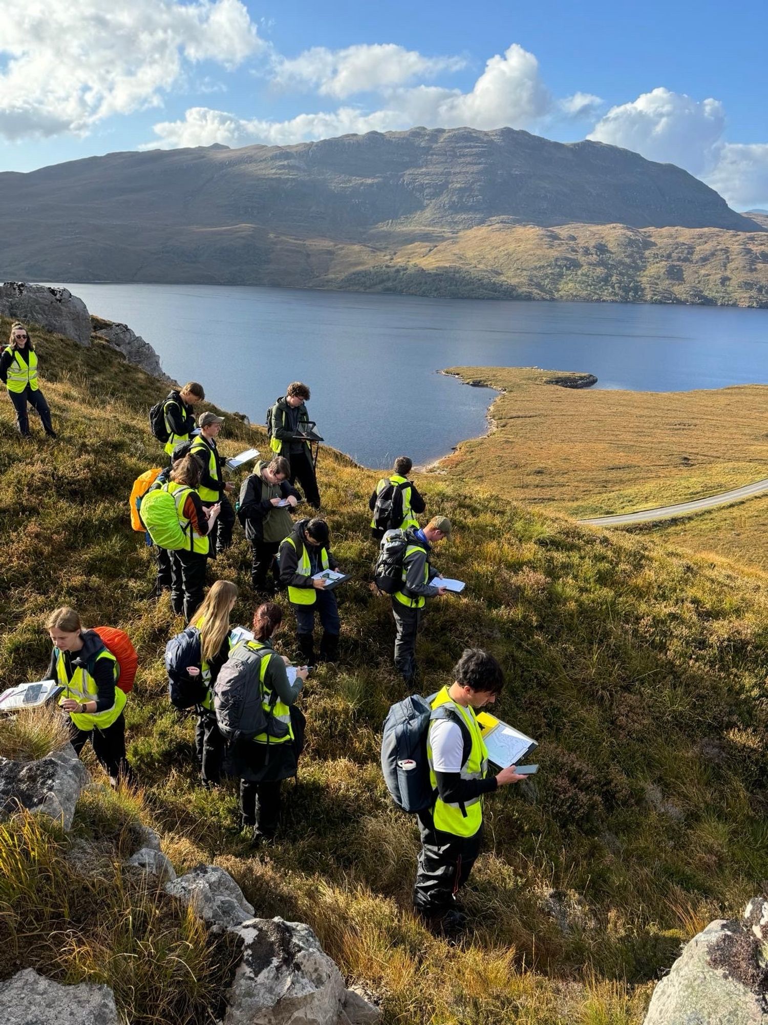 Student mapping with view of Loch Assynt in the background