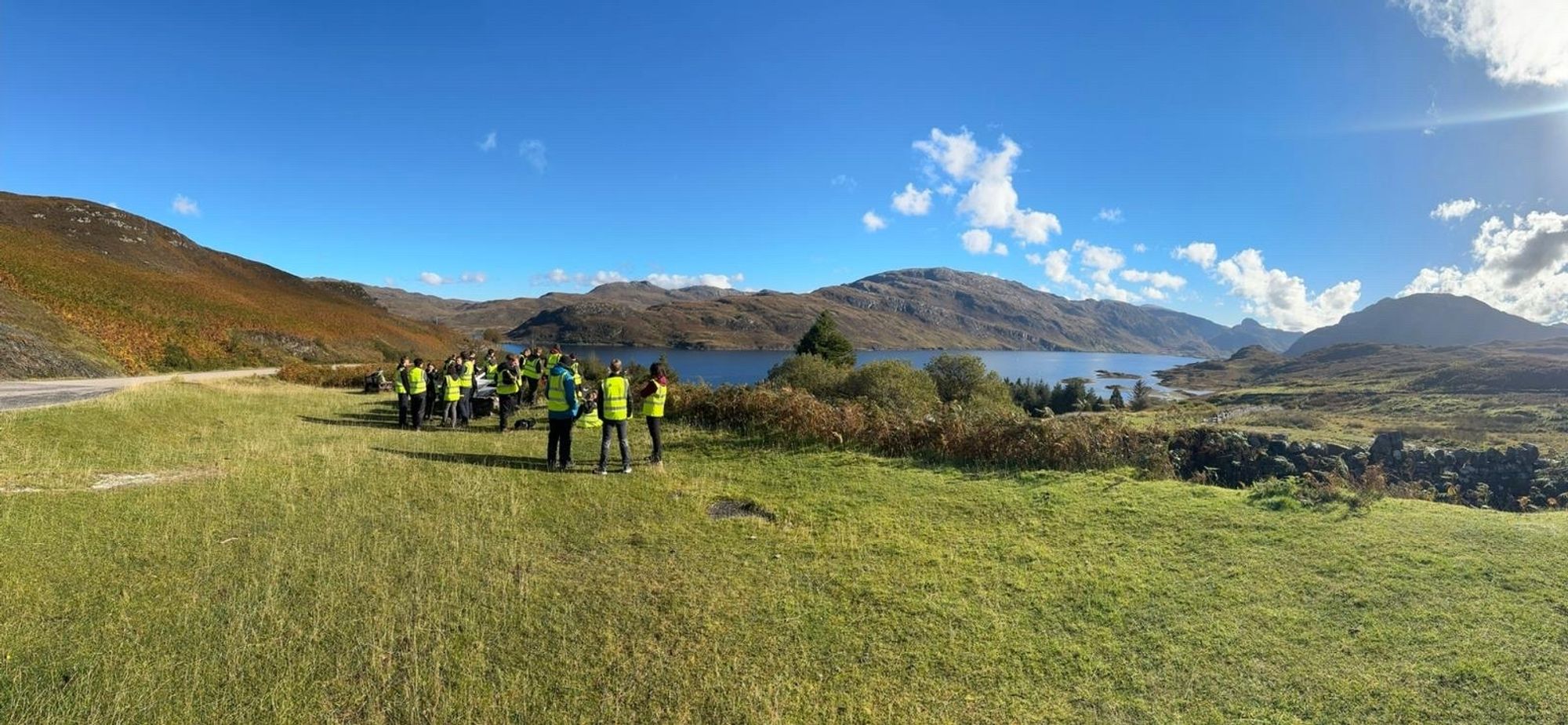 NW Scotland in sunshine - group of students studying an outcrop