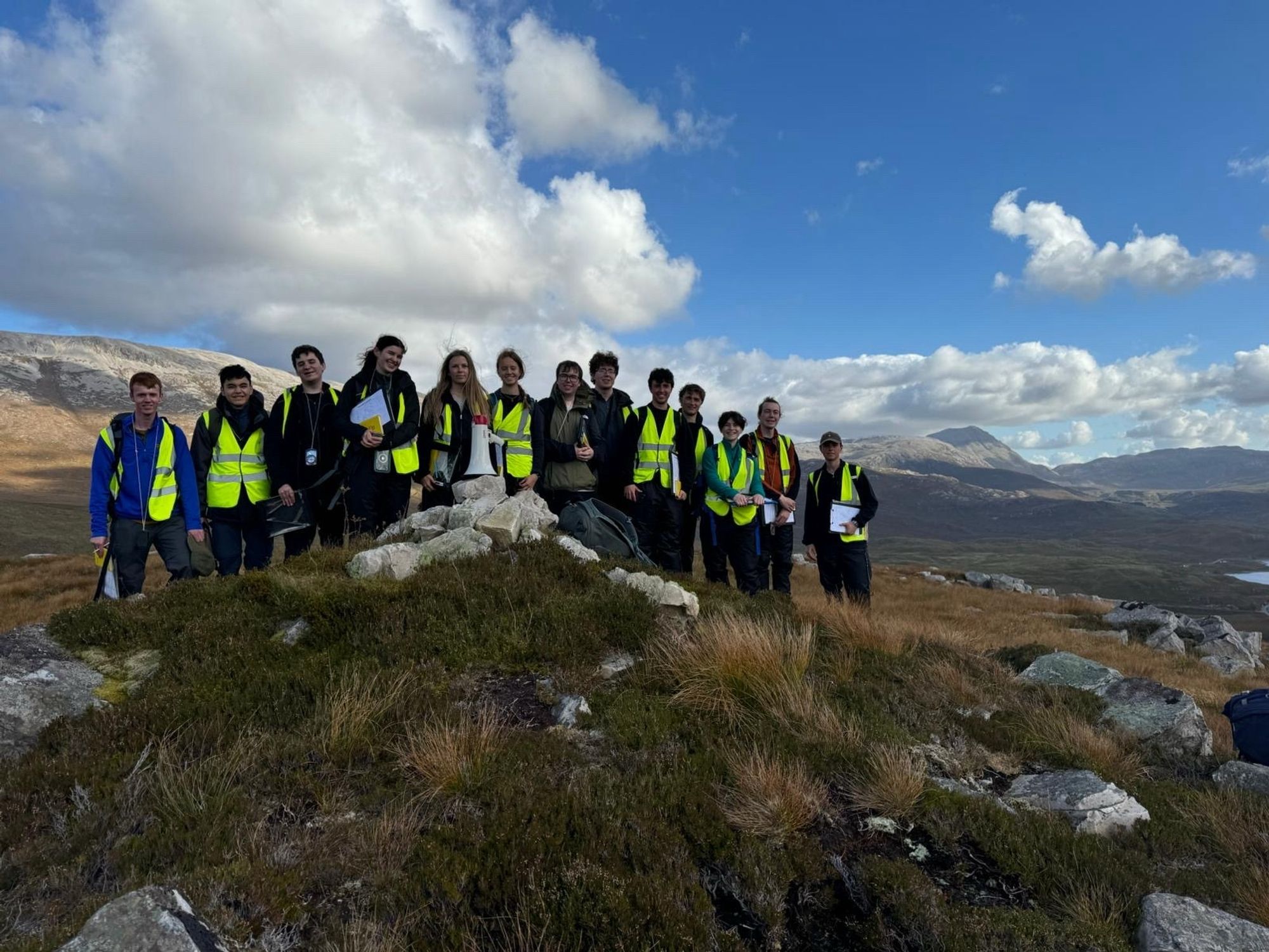 Students on top of small hill with Connival in the background