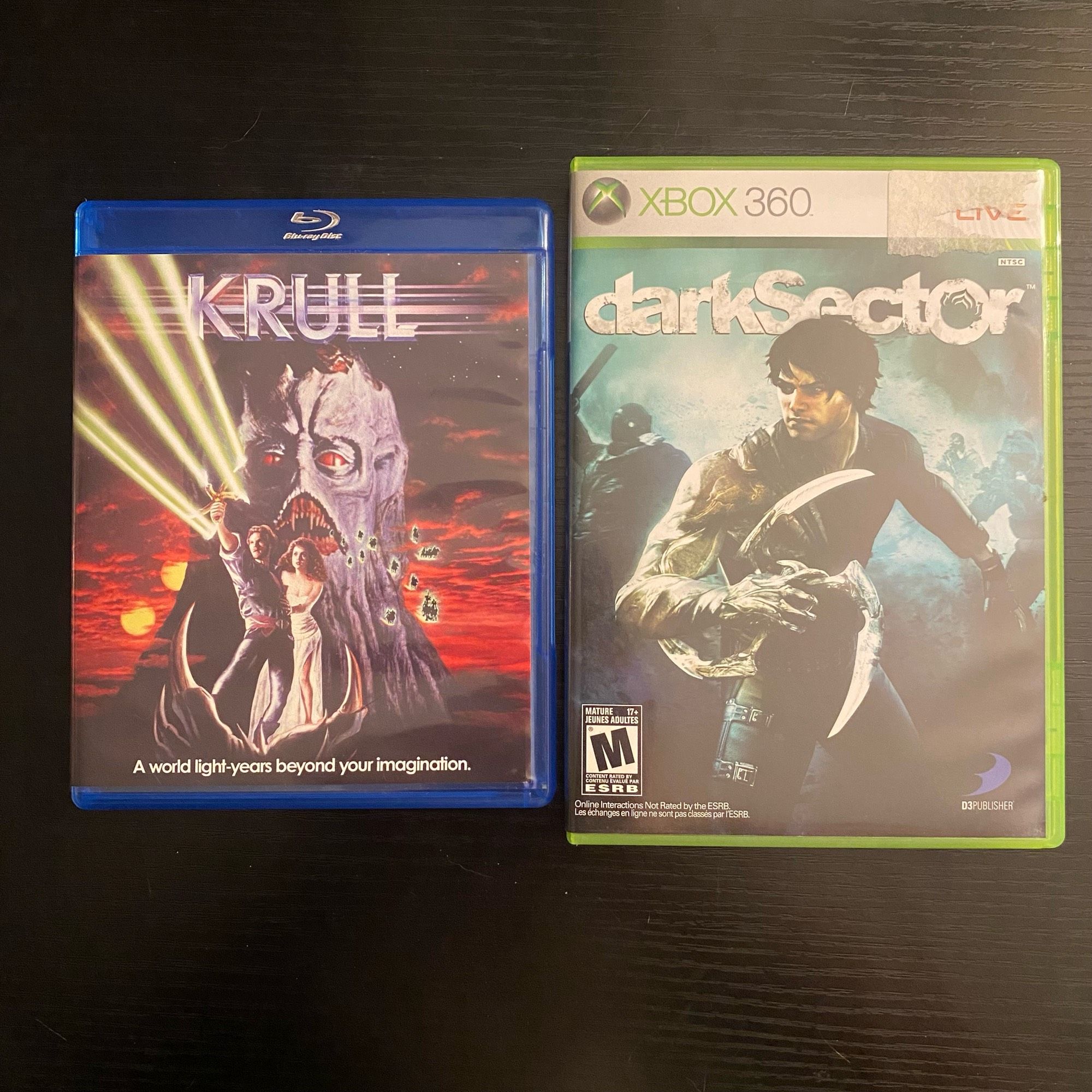 Copy of Blu-ray of Krull next to a copy of the Xbox360 game Dark Sector.