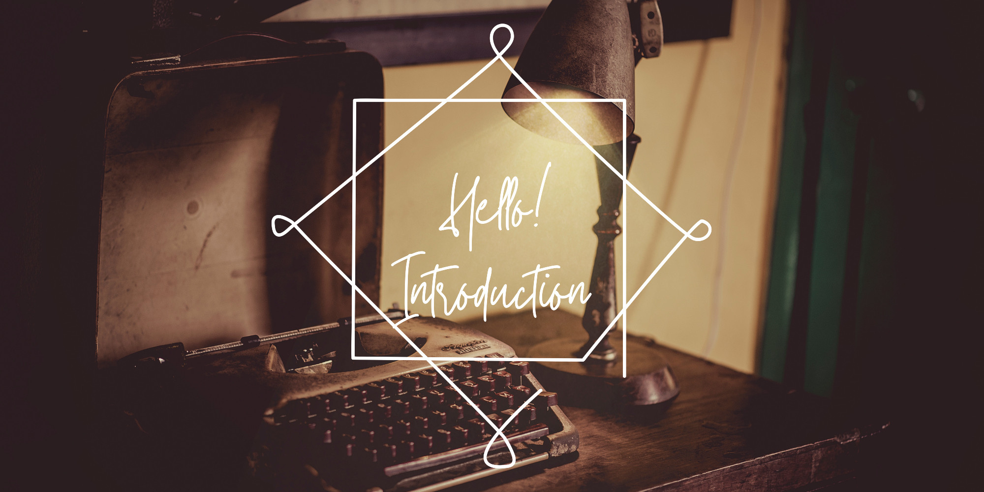 A photo of an old typewriter on top of a wooden desk, with an old fashioned copper lamp beside it shedding a ray of light on the typewriter. Over the image there is an icon of a white diamond shape with round edges and inside the diamond the words "Hello! Introduction" are written in a white font mimicking flowery handwriting.