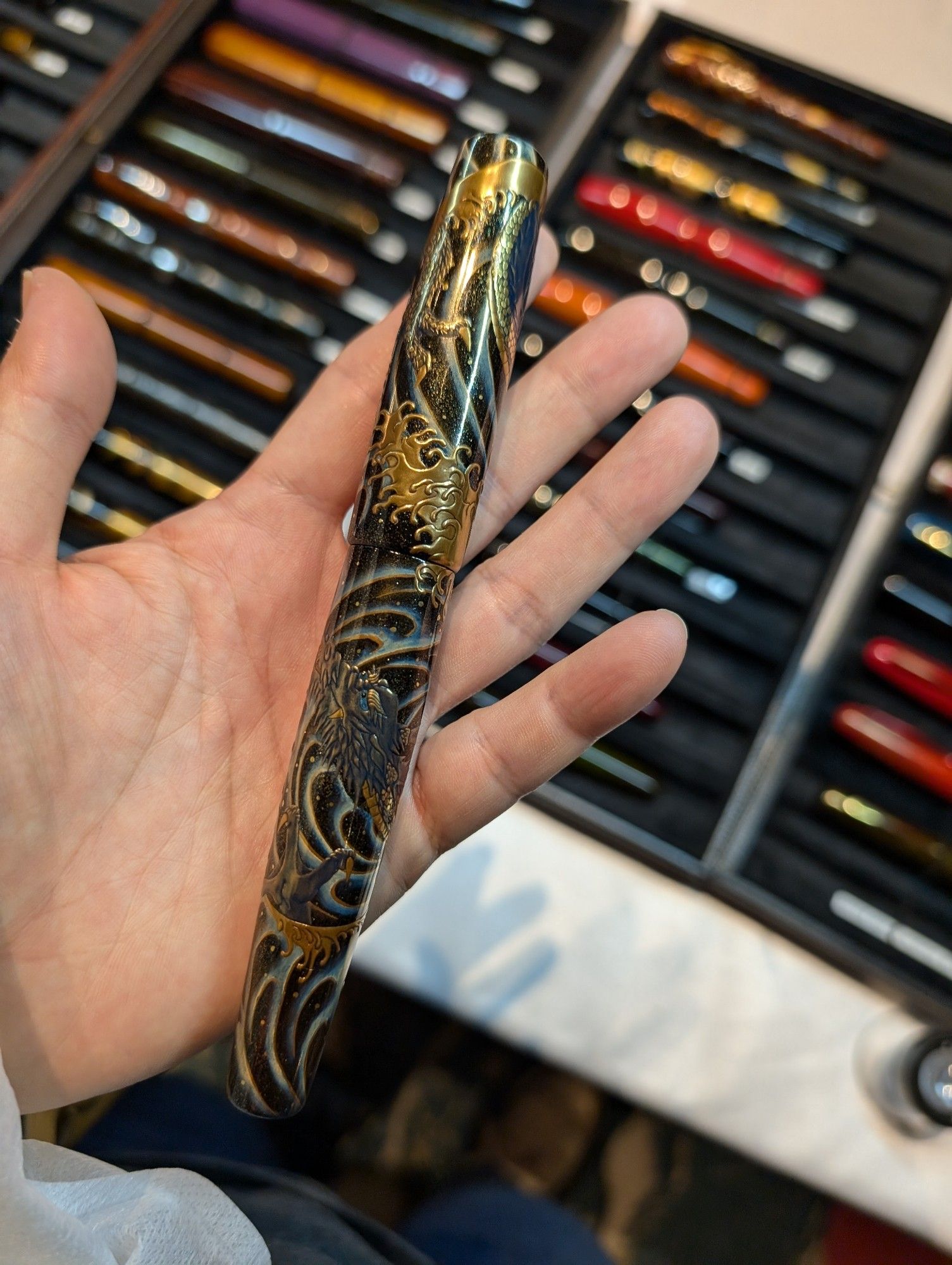 a Urushi lacquered pen with a very detailed golden dragon design