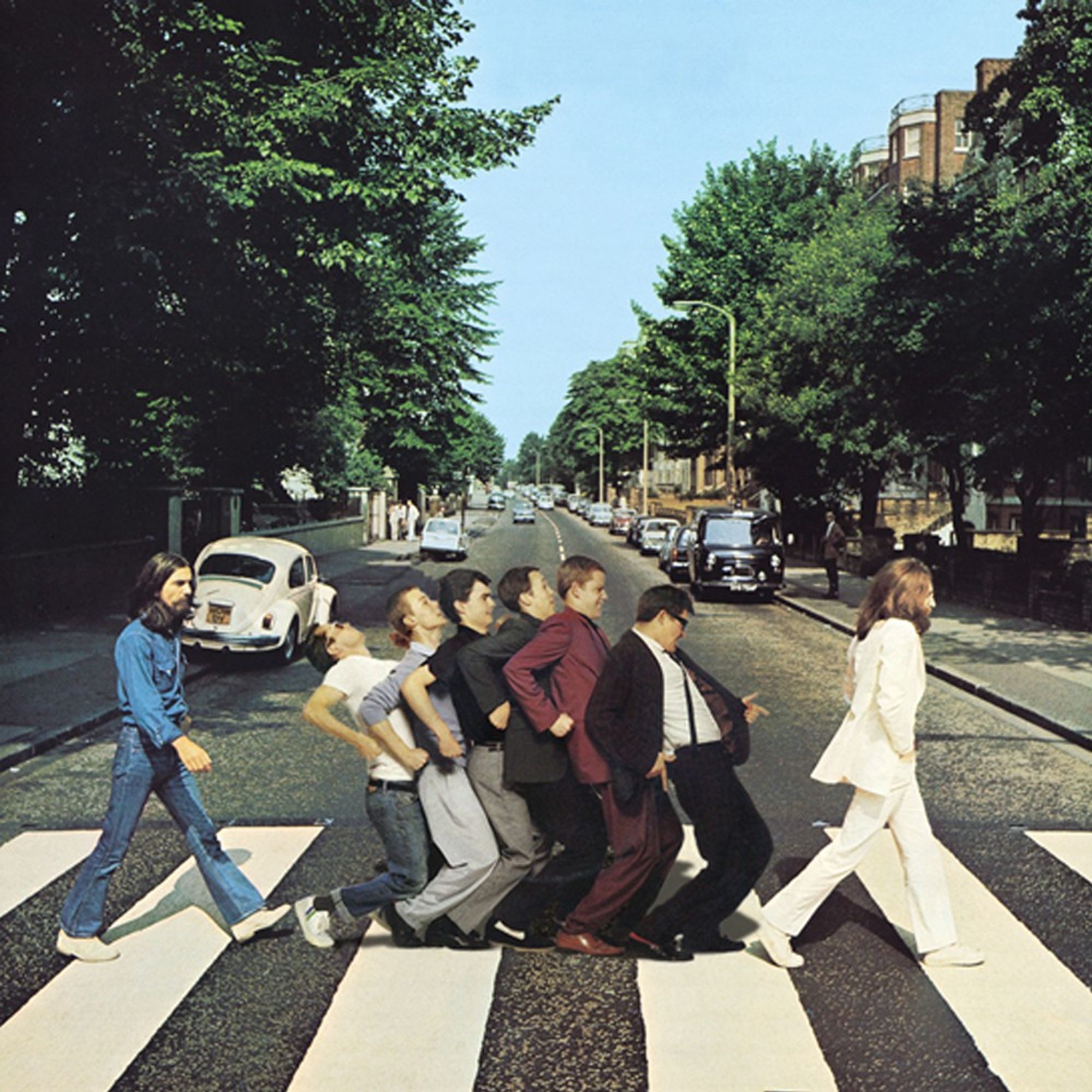 The Abbey Road album cover. Paul and Ringo have been replaced on the zebra crossing by Madness in nutty train mode (a colour version of the black and white photo used on the cover of their album One Step Beyond).