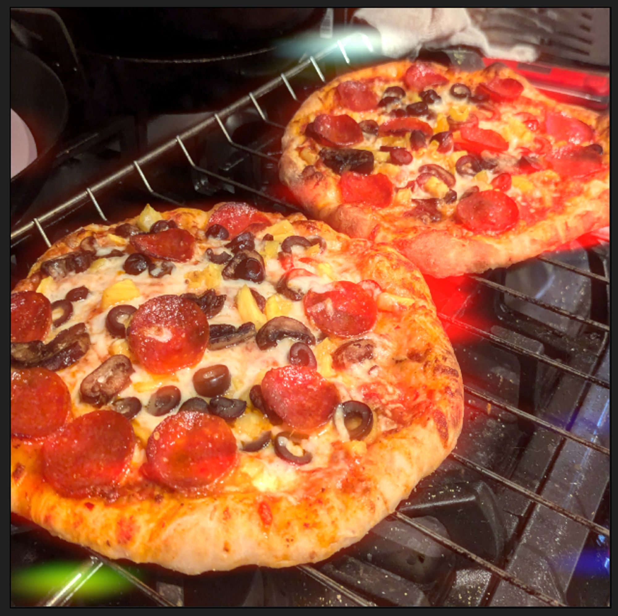 photograph of a pizza. ive been experimenting with shaders to emulate filmic halation and bloom in an anamorphic format.