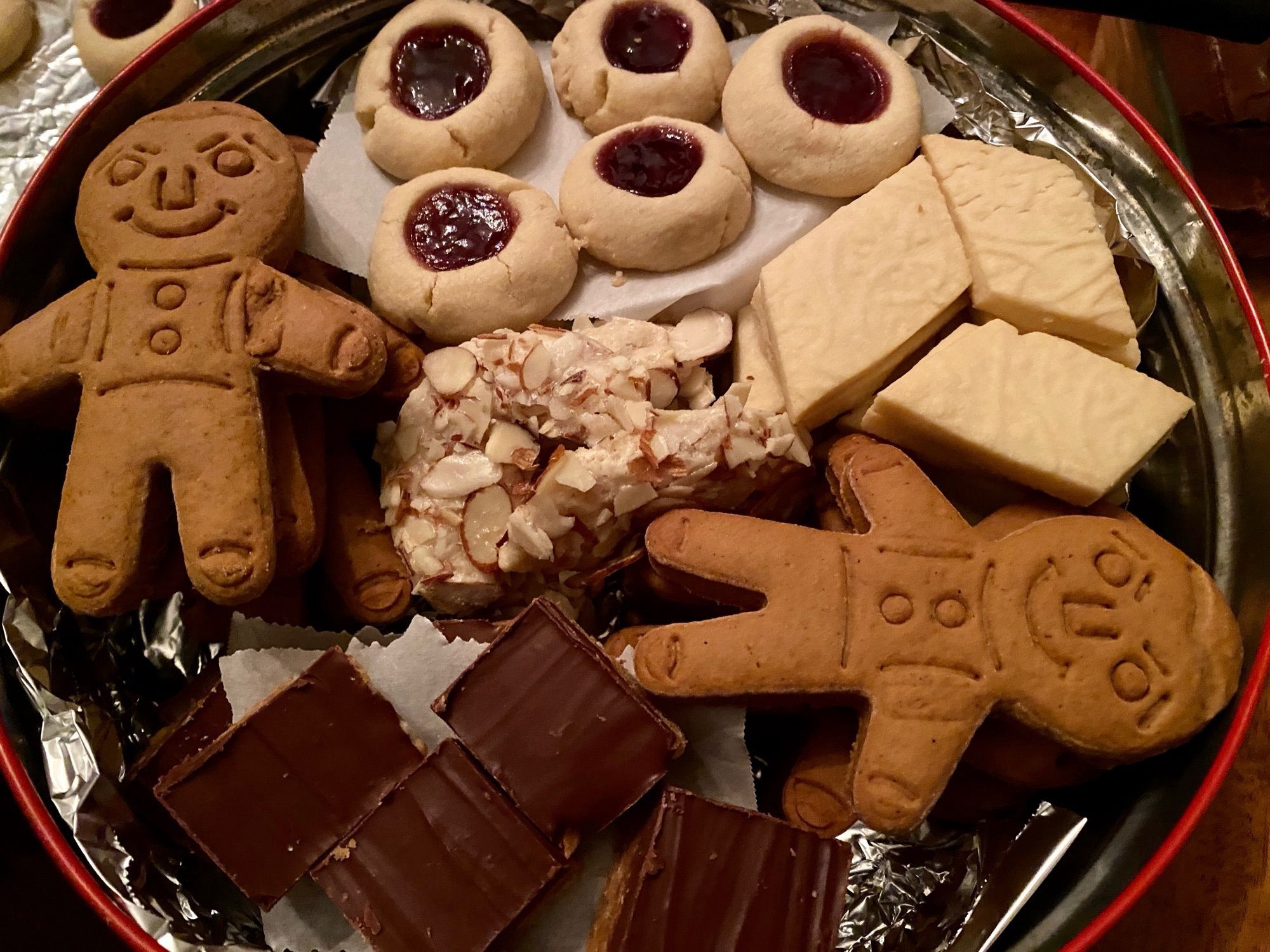 xmas cookies in a tin: gingerbread boys, thumbprint cookies, embossed shortbread diamonds, butterscotch squares, almond crescents