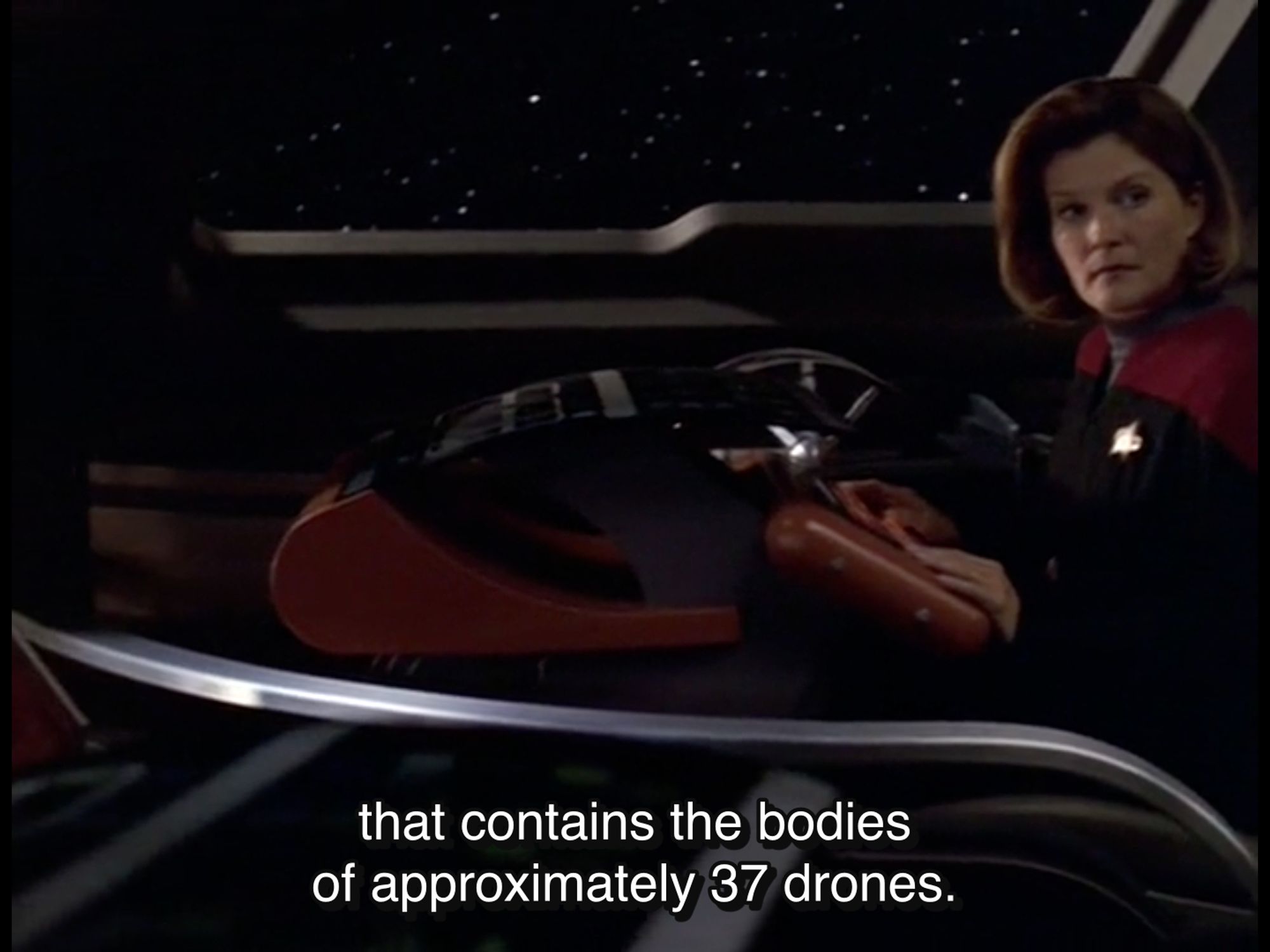 The same scene a moment later. The camera is sweeping through the Delta Flyer, so Tuvok is now out of frame, but we see Janeway looking at him as he continues: "that contains the bodies of approximately 37 drones."

From Star Trek Voyager, Season 7, Episode 2, "Imperfection"