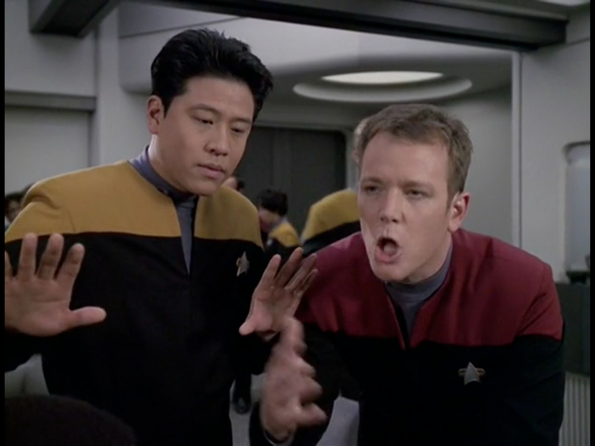 Harry, his eyes still downcast, now has his hands spread out wider in front of him. Tom, still hunched over, has his mouth open in a perfect 'O,' like a howler monkey. His hand is in front of him, blurry as though in motion.

From Star Trek Voyager, Season 6, Episode 11, "Fair Haven"